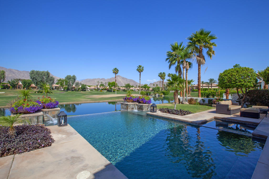 Location! Location! Enjoy unparalleled living at its finest in prestigious Ranch La Quinta Country Club. Captivating west panoramic views of Santa Rosa Mountains, a pristine lake & 13th fairway of the Robert Trent Jones Course. Enjoy the awe inspiring sunsets! This is a rarely offered Montana I plan ideally located on a secluded cul-de-sac. One of the most sought out plans with its spacious open design concept. Enter through the charming courtyard & be immediately greeted with a waterfall feature. Enjoy the dramatic views from the moment you enter the wrought iron entry double doors. The high volume rotunda overlooks stunning views of the open living spacious great room and formal dining room; floor to ceiling rock fireplace; media entertainment center; gourmet kitchen with granite counters; Island, wet bar, an array of stainless steel appliances & informal cozy dining area near-by. Large fleetwood slider doors frame views of the beautifully landscaped backyard, custom infinity edge pebble tec pool & a spa and exciting majestic mountains & mesmerizing lake. The private owner's suite opens directly to the Infinity Pool & exterior spa & features a lavish fireplace. The bathroom suite features a sunken jetted tub; double shower; 2 separate marble vanities & a huge walk-in closet. Two additional guest bedrooms are in the other wing and provide a great separate allocation of privacy and space. 3 car spacious garage. The special assessment of $27,866 for renovation of the club house; racquet club & our new fitness center has been fully paid off. Furnished per seller's approved inventory. Come and create the lifestyle that you deserve!--