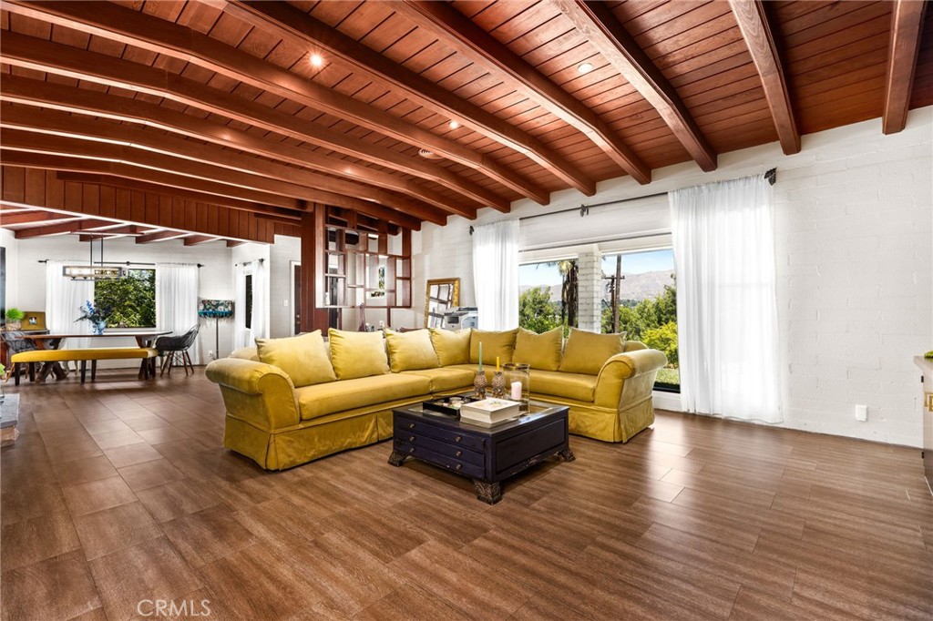 Welcome to 1872 Arroyo Drive — a one-of-a-kind mid-century gem perched in one of Riverside’s most sought-after neighborhoods, Victoria Woods down the street from the historic Victoria Country Club. This home is full of character, style, and warm architectural details you just don’t see every day. Step out onto your front porch with a cup of coffee and take in breathtaking views that span the city. Inside, you’ll find stunning wood beam ceilings, floor-to-ceiling windows, and timeless craftsmanship that make this home feel as special as it looks. Thoughtfully designed with abundant storage throughout, this home also offers a rare opportunity to add a Junior ADU — without sacrificing any existing bedrooms or bathrooms. It’s a perfect setup for multi-generational living or generating passive rental income. Out back, enjoy your private yard with space to relax in the hot tub and unwind with a glass of wine under the stars, and drive your golf cart over to Victoria Country Club. Don’t miss your chance to own a true Riverside original. This home is even better in person — schedule your showing today!