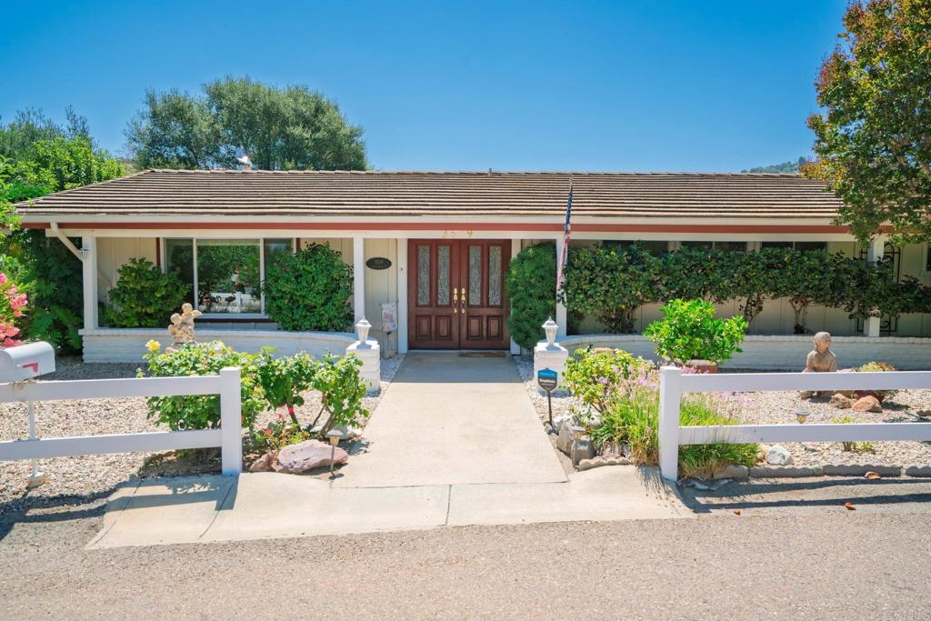 Welcome to 3519 Cherrybrook Court—a hidden gem tucked away in the heart of Fallbrook’s scenic Gird Valley. This charming single-story ranch-style home offers 2 bedrooms, 2 bathrooms, and 2,024 sq ft of living space on a generous 10,357 sq ft lot. Set on a quiet cul-de-sac, this property offers rare privacy and stunning backcountry vistas. The curb appeal is warm and inviting with low-maintenance landscaping and a sweet, country feel. Step through the double beveled-glass entry doors into an open floor plan filled with character: vaulted ceilings with exposed beams, a cozy fireplace framed by an adobe brick wall, and a formal living room perfect for relaxing or entertaining. The kitchen features a pass-through window to a nearly full-length sunroom—ideal for enjoying morning coffee or afternoon breezes year-round. The spacious primary suite includes French doors that open to a patio with a breathtaking view, a walk-in closet, and a beautiful custom walk-in shower. The second primary suite is light-filled and comfortable, perfect for guests or a home office. The property offers a peaceful escape with fruit trees galore—Asian pears, lemons, figs, and oranges—as well as two storage sheds and a bonus space that makes a wonderful yoga studio, art room, or office. Meander through the backyard and discover your own secret garden tucked into the landscape. Live Oak Estates provides a tranquil, country living experience and is just a short stroll from Monserate Winery. You'll enjoy access to top-tier vineyards, local trails, and Fallbrook’s unique small-town charm. This is your chance to live in the heart of "Vineyard Valley," where every day feels like a getaway. All this, yet conveniently close to Fallbrook's shopping and dining. Only 2 miles north of the 76, 5 minute drive the the I -15, and 30 minutes to the Oceanside Harbor! Let the fun begin!