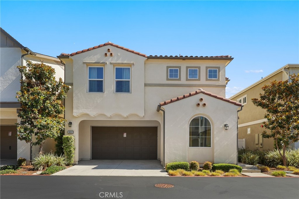 Tucked into one of the most private and desirable spots in Aura—a newer enclave of detached homes in Costa Mesa—this 2,225 sq ft residence offers the ideal blend of modern design, comfort, and coastal convenience. Located just minutes from the beach, Segerstrom Center for the Arts, and world-renowned South Coast Plaza, this home delivers an unbeatable lifestyle.
The two-story layout features 4 bedrooms—including one on the main floor—3 full bathrooms, and a versatile loft/bonus room perfect for a home office, playroom, or retreat. An open-concept design with soaring ceilings and abundant natural light highlights expert craftsmanship and sophisticated finishes. Features include; Central A/C and dual-pane windows, Wide-plank wood-look waterproof laminate flooring, LED recessed lighting and designer fixtures, Gourmet kitchen with European quartz counters, white shaker soft-close cabinets, large island with pendant lights, deep farmhouse sink, and premium Italian Bertazzoni appliances, and an Elegant staircase with white wood railings and tall raised-panel doors. The private, low-maintenance backyard features pavers, block wall, and vinyl fencing—perfect for outdoor dining or entertaining. Upstairs, the primary suite offers dual walk-in closets and a spa-style bath with a large walk-in shower (multiple heads, bench, frameless glass), dual vanities, and private water closet. Two additional bedrooms share a full bath, and the upstairs laundry room includes a utility sink and built-ins. Additional highlights include a two-car garage, full driveway, home warranty through 2029, and access to Aura’s private park with playground and BBQs.