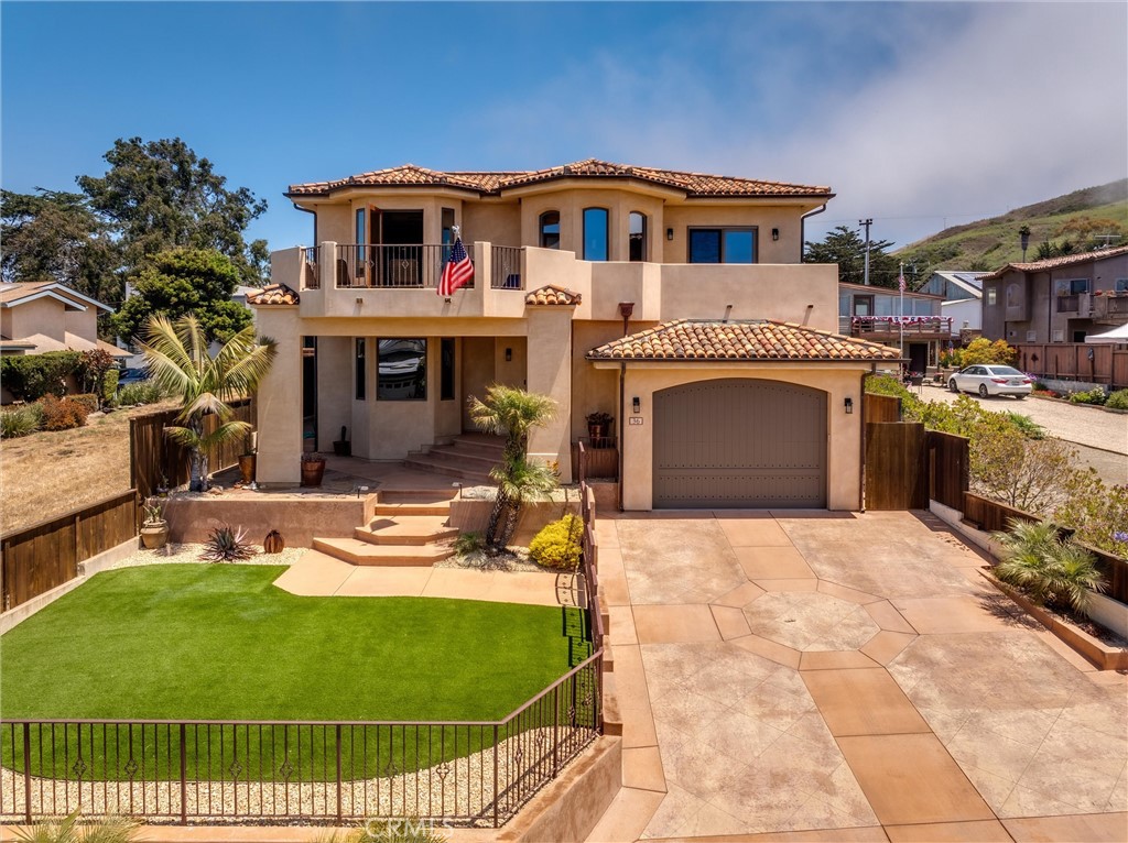 Authentic Spanish Style Meets Modern Coastal Living
THE best Cayucos location—“Old Town” with big, wide streets, just a short walk to the pier, beach, and downtown! Gracefully blending authentic Spanish design elements with a flowing contemporary floor plan, this exceptional home offers both striking style and versatile functionality. Thoughtfully designed with outstanding separation of space, it features quality coastal views and a layout that adapts to a variety of lifestyles. An impressive set of broad exterior steps leads to a grand entryway with a massive door that opens into a spacious foyer. Just off the entry, a cozy sitting area with open beam ceilings captures coastal vistas—creating a perfect place to relax. The lower level includes a spacious game room with a fireplace—ideal as a billiards room or easily adaptable for other uses. In addition to two guest bedrooms sharing a luxurious full bath, there is a third full bedroom and an additional full bathroom on this level, offering excellent flexibility. Laundry facilities are also conveniently located downstairs. A graceful oval staircase leads to the upper floor, where you’ll find the main living areas, including the open-concept living room, dining space, kitchen, and the expansive primary suite. The living room showcases a full bar with a dedicated beverage fridge and sweeping views of the coastline and downtown Cayucos. The island kitchen is a chef’s dream, offering custom cabinetry, stone countertops, a double oven, and a massive refrigerator. Every detail is thoughtfully curated for both function and style. At the rear of the property, an oversized garage with alley access includes a brand-new, spacious ADU with its own private entrance. Designed with the same Spanish-style charm, this 2-bedroom, 2-bathroom unit features one bathroom with a tub/shower combo and another with a walk-in shower. The ADU also includes enclosed garage parking and ample driveway parking in both the front and rear. Perfect for multi-generational living, guest accommodations, or potential rental income, this additional unit adds flexibility and value.
This one-of-a-kind home truly must be seen to be appreciated. Don’t miss your chance to own a stunning blend of coastal elegance and architectural charm in the heart of Cayucos.