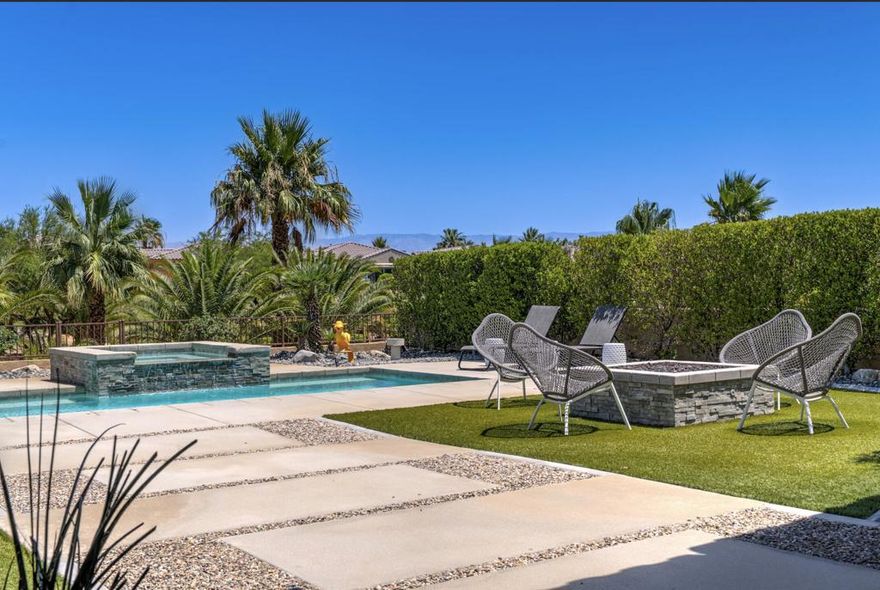 Enjoy the best in country club living in this immaculate freestanding villa, on FEE land, at the coveted Desert Princess.  Sold with many of the beautiful furnishings in place, this amazing property has it all! High ceilings and an open airy floor plan lets you entertain in style.  Relax in the spacious living room with its cozy fireplace and reclaimed wood shelving under clerestory windows.  The large dining room leads into the kitchen with timeless granite counters, stainless appliances (including a 5 burner gas range and wine cooler) plus a freestanding island.  Both large en-suite bedrooms are tucked privately down the hall, including the primary with its custom walk in closet and huge bathroom offering a large shower, separate soaking tub and double sinks.  A bonus den(which easily converts to a 3rd bedroom) and separate powder room are included for your convenience.  Then spread out on your covered terrace or walk across your huge private yard to your own waterfall saltwater pool and spa.  Enjoy dinner and cocktail hour overlooking a tranquil palm grove and walking path with majestic San Jacinto Mountain views.   A raised firepit, outdoor shower, 2 car garage, newer Culligan water filtration, a tankless water heater and too many extras to mention, completes this perfect picture.  Out your door enjoy Desert Princess' resort lifestyle with a fitness center, full service spa, tennis, pickleball, bocce ball, basketball, 27-hole championship golf course with preferred tee times and homeowner discounts, driving range, 3 practice greens and golf shop with on-site professionals. The clubhouse has a restaurant and bar (and no social membership fee), homeowner discounts at the Club and the on-site Doubletree Palm Springs Golf Resort Hotel by Hilton + EV charging. You'll be minutes from downtown Palm Springs shopping, nightlife and theaters.  Your HOA dues conveniently include cable tv, exterior water, trash, recycling and common landscape maintenance. With short-term rentals allowed, this home offers the perfect blend of lifestyle and investment potential.  Welcome home!