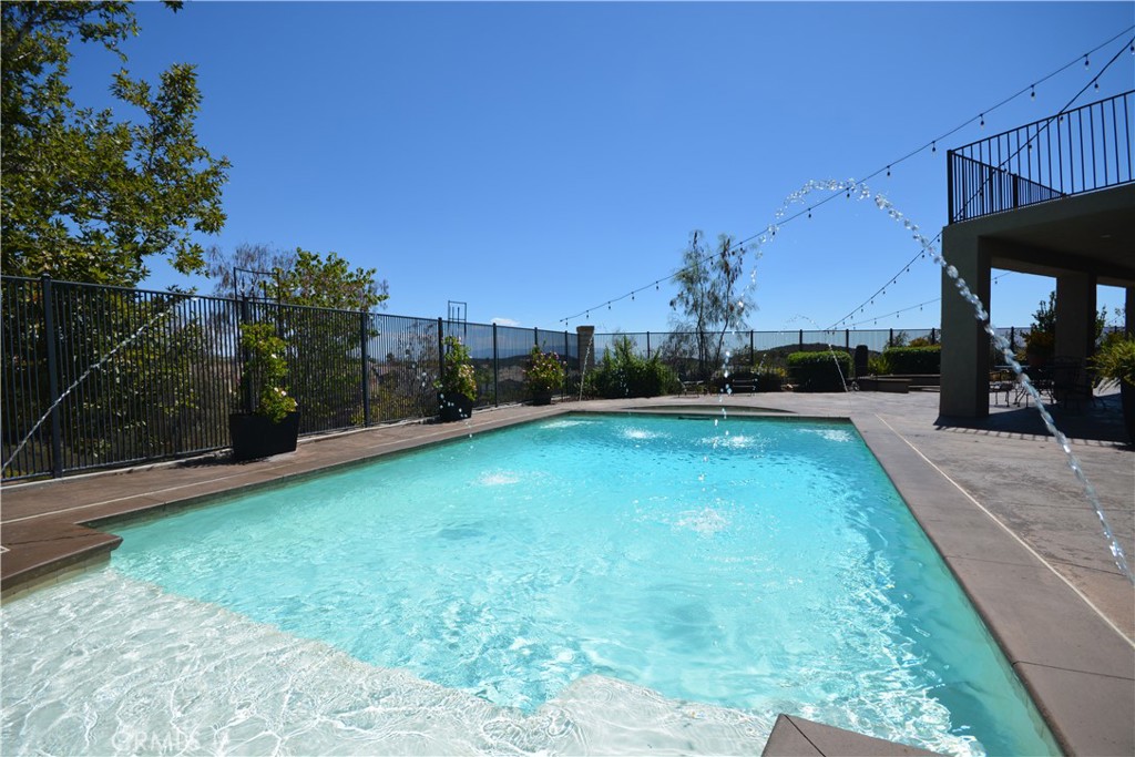 Incredible opportunity to own this executive home with all the features buyers request most. Panoramic views, pool, main floor bedroom, quiet cul de sac location for privacy, No HOA dues, solar and low, low tax rate keep this home affordable! Enter through a covered front porch to the formal living room to see that the whole home has new hard wood flooring, new light fixtures, plantation shutters and more. Pass through the formal dining room to the spacious great room at the rear of the home which features a family room space with fireplace, eating area and impressive kitchen with granite counters, stainless appliance package, pantry, center island and absolutely loaded with cabinet and counter space. All of this looking out to the heated saltwater pool, spa, firepit and 180 degree views of all of Temecula, the hills and city lights. Main floor bedroom with its own bath and large laundry/mud room complete the main floor. Second floor features a massive loft/family room, 3 large guest bedrooms and an amazing primary suite with it's own private retreat/bonus room, luxury 5 piece bath, walk-in closet and private balcony/deck to take in the breathtaking views. New A/C and solar keep it cozy and comfortable. Outside, sculpted concrete patio, sunken fire pit, pool, covered dog run, and fruit trees all on a lot that you just can't find anywhere else. Home water softener filtration system, new perimeter fencing, removable locking security pool gate and so much more. Close to parks, top rated schools, shopping, award winning wineries, and with easy freeway access for commuters. Homes with all these features are hard to find, and even harder to forget, if you let it pass you by!