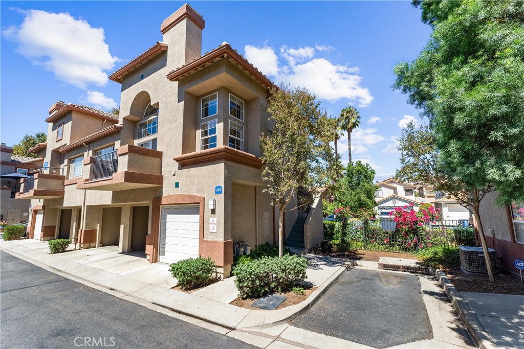 FHA approved! $15,000 Down Payment Assistance grant available for qualified buyers.
Welcome to this beautifully upgraded two-story condo in the desirable Villaggio community of North Corona. Whether you’re a first-time homebuyer, looking to rightsize, or seeking a strong investment opportunity, this home offers the perfect blend of style, comfort, and convenience. As you enter the home you’ll find durable engineered wood flooring, vaulted ceilings, and an abundance of natural light streaming through the open floor plan. The dining area opens to sliding glass door that lead you to an inviting first-level balcony, seamlessly blending indoor and outdoor living. The main level features a generously sized bedroom with a private ensuite bathroom, dual sinks, quartz countertops, and a walk-in closet. Upstairs, a spacious loft offers endless possibilities to use as a second bedroom, home office, gym, or creative studio. The loft level also includes a private bathroom with step-in shower, quartz countertops, and a private secondary balcony for enjoying quiet outdoor moments. The spacious kitchen is designed for everyday living and entertaining, with an abundant of storage, quartz countertops, stainless steel sink, stainless steel appliances, Samsung refrigerator that is included with the home. An in unit laundry closet with additional storage located on the main level. Additional highlights include a private one-car garage located directly below the unit, along with convenient open carport-style parking. This corner unit is exceptionally private with no one above or below and only one shared wall. The well-maintained Villagio community provides resort-style amenities, including a sparkling pool, spa, BBQ picnic area, and landscaped greenways perfect for walks, gatherings or unwinding after a busy day. This home offers a convenient lifestyle in one of Corona’s most sought-after neighborhoods. The home is close to shopping and dining yet tucked away among a neighborhood of single family residences. Easy access to both the 91 and 15 freeways.
2925 Via Toscana #202 is an incredible opportunity you won’t want to miss!