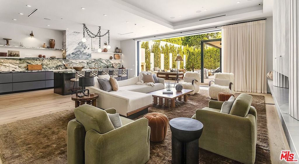 After purchasing this newly constructed home in 2021, the owners engaged renowned designer Jeremiah Brent to transform and re-imagine property. The result of their multi-million-dollar, year-long collaboration is an extraordinary marriage of exceptional craftsmanship and distinctive finishes and was recently featured in Architectural Digest. Every element of this property is a work of art, yet the home's overall ambiance is warm, livable, and inviting. Stunning light fixtures from Apparatus and Trueing grace the entry, dining room and kitchen. Gorgeous stonework can be found throughout the house, including a show-stopping Macchia Vechia marble bar, hand-carved Bardiglio Nuvolato fireplace, and Calacatta marble counters and backsplash in the kitchen. The redesign of the backyard was done with as much care as the home's interiors, including the addition of limestone paths and patios, gorgeous outdoor kitchen with hardwood trellis cover, charming outdoor fireplace with antique plinth, and lounging areas around the pool and spa. All systems have been upgraded to the absolute top-of-the-line, from a state-of-the-art security system to the home theatre and audio systems (indoor and out). With five ensuite bedrooms, gourmet chef's kitchen, theatre, private resort-style backyard, and detached pool house/home gym, this property has something for everyone. Jeremiah Brent's furnishings and decor (including many curated vintage and antique pieces) are available for purchase for an additional price, making this a truly one-of-a-kind offering for the most discerning buyer.
