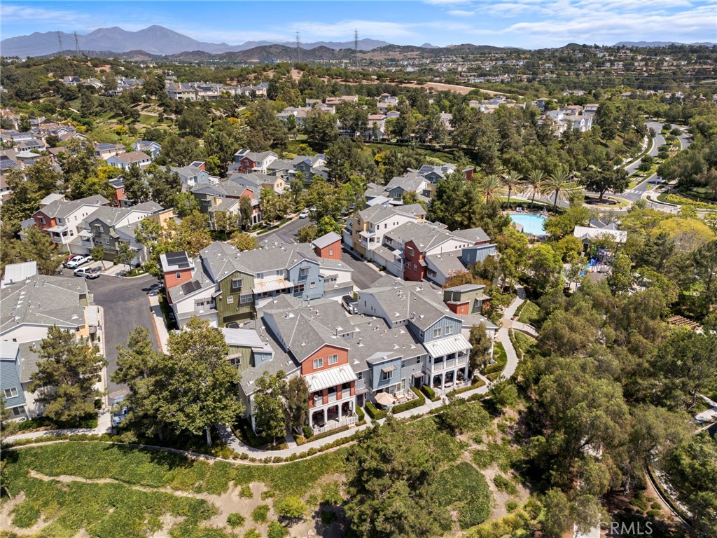 Welcome to 34 Platinum Circle—an upgraded, turnkey townhome in the heart of Ladera Ranch! This beautifully remodeled 2-bedroom, 2.5-bath home with a bonus loft/office offers nearly 1,500 sq. ft. of stylish living space, perfectly situated on the scenic Paseo Trail with views of lush open space, hills, and parks. From the moment you enter, designer details set this home apart—custom woodwork, decorative moldings, and a welcoming entry with practical built-ins for backpacks and bags. Luxury vinyl plank flooring flows throughout the main level, complemented by updated lighting and abundant natural light. The chef-inspired kitchen has been completely refreshed with Calcutta Quartz countertops, a decorative backsplash, stainless steel appliances, a functional center island, and an oversized pantry. The adjoining dining and living spaces open to a private balcony, perfect for relaxing outdoors. Additionally, you’ll find two bedrooms and a versatile loft/office with walnut desk and shelving, enjoying mountain views. The primary suite showcases a barn-door entry to the remodeled bathroom and walk-in closet, while the second bedroom offers an en-suite bath and custom finished closet organizer. Additional updates include remodeled bathrooms, custom closet finishes, and thoughtfully designed storage throughout. Enjoy the best of the Ladera Ranch lifestyle—walk the Paseo Trail to nearby parks, pools, the newly renovated water park and Oso Grande Elementary. With upgrades in every corner and a location that blends convenience with natural beauty, this home is truly move-in ready.