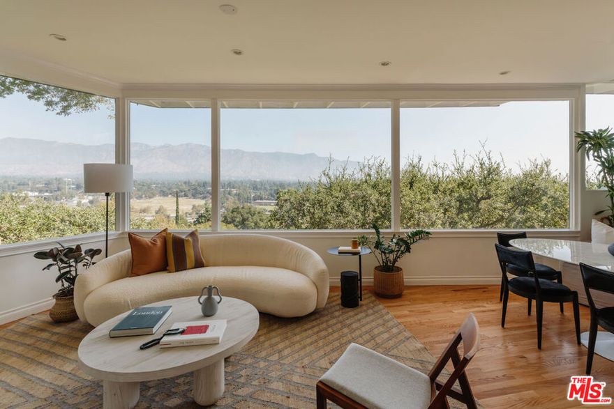 Perched on a 14,000 sf lot, this architectural work of art by W. Melville Garten offers the ultimate in privacy and refinement. Located in Pasadena's coveted Linda Vista neighborhood, this 3-bedroom, 3-bath with a guest house commands breathtaking views of the San Gabriel Mountains and the iconic Rose Bowl. Expansive windows flood the open living and dining areas with natural light, framing uninterrupted vistas that blur the line between indoors and out. At the heart of the home, the chef's kitchen boasts new quartz countertops, a wine fridge, and premium stainless steel appliances, and flows onto a spacious patio perfect for al fresco dining with sweeping views. On the main level, a versatile bedroom serves equally well as a guest room or study, paired with a nearby bathroom highlighted by a classic clawfoot tub. The lower level is anchored by a tranquil primary suite with a private deck, expansive walk-in closet, and spa-inspired bath featuring a deep soaking tub, separate dual-head shower, and double vanity. Along the same hall, a third bedroom and a den, both featuring floor-to-ceiling glass doors that open to the back deck and garden, are complemented by an updated bathroom with a soaking tub and steam shower. The backyard is a dream for outdoor living and entertaining, featuring numerous seating areas and pathways that wind through lush grounds landscaped by the incredible Chaparral Studio Gardens. The detached guest house offers the perfect retreat for visitors or a creative workspace. A two-car garage with EV charging plus three additional spaces provides ample parking. 910 Glen Oaks Boulevard embodies the rare union of architectural legacy and modern comfort, where seamless indoor-outdoor living, inspiring views, and a tranquil sense of retreat define exceptional Pasadena life.