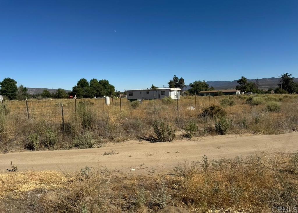 A good buy in good location! It has a 1 bedroom, 1 bath mobile home & a permitted water well. 2.17 acres fully fenced compacted for vehicles to enter & exit. A corner all usable lot with views of the mountains. You may build 2 to 5 units!(Check with the city.) A lot of potential for many uses. Build your new home, workshop & room for RV and many other toys. Only 5 mimutes to Cahuilla Casino, just 25 minutes to the beautiful Idyllwild, 30 minutes to Temecula. Close by are Julian, Palm Springs, Hemet & Warner Springs. Minutes from Hamilton Elementary & Hamilton High School ! Previous owners already started applying for the residential address & permanent foundation for the mobile home permits with the city.