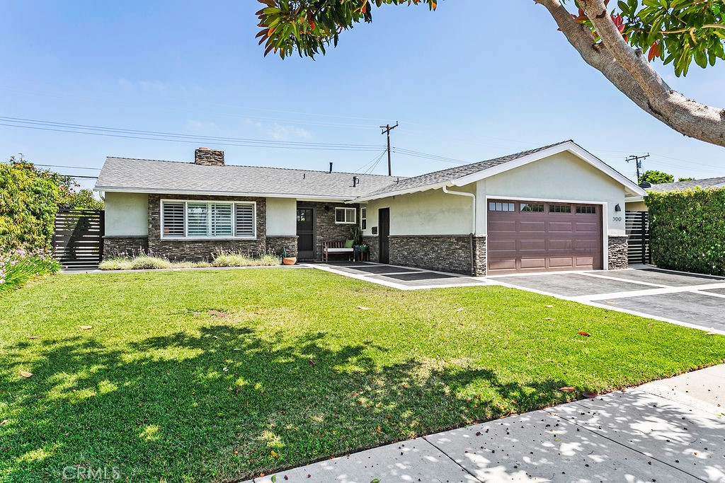 Beautifully updated home featuring a spacious expanded kitchen with a separate pantry and convenient interior laundry area. Enjoy year-round comfort with central air conditioning and a fireplace. Both bathrooms and the kitchen have been tastefully remodeled with modern finishes. Stylish plantation shutters throughout. Closet organizers. The home also boasts stamped concrete in the front and backyard, plus built in planters with seating, offering low-maintenance outdoor spaces ideal for entertaining. A versatile backyard studio provides the perfect space for a workshop, hobby room, or additional storage.