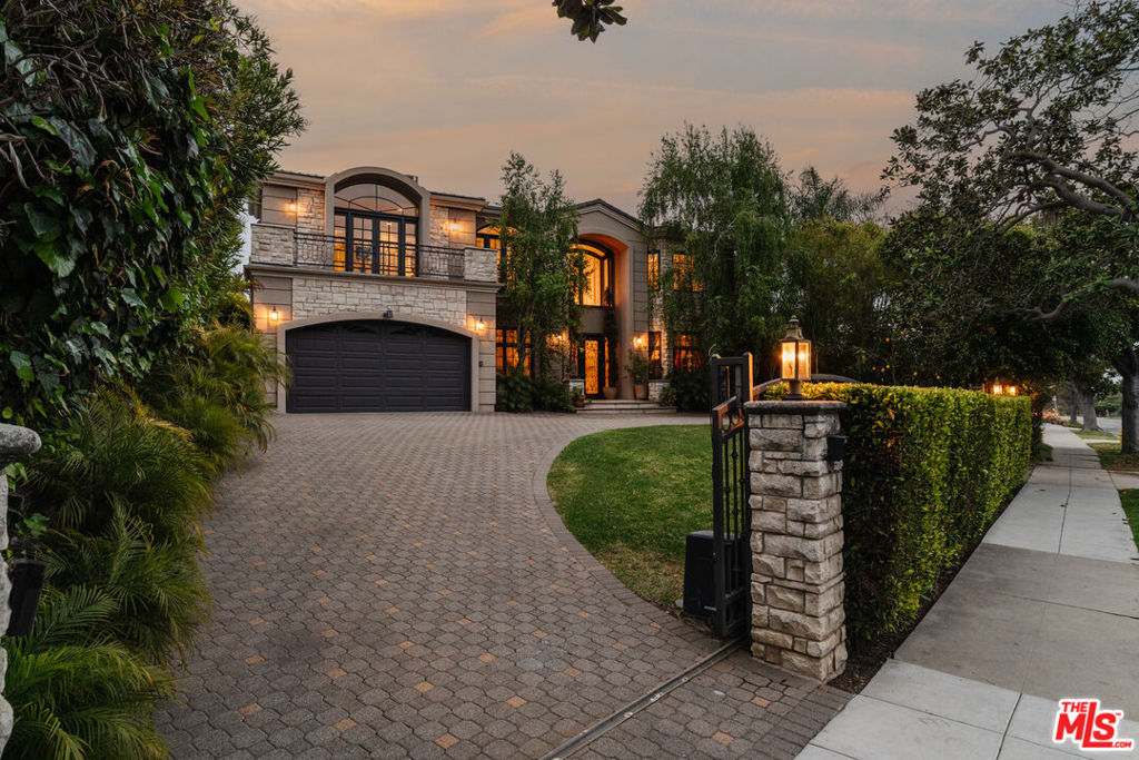 Located North of Montana, this grand estate offers a refined living experience with multiple spaces designed for both everyday comfort and elevated entertaining. Privately gated and secured by a hedged motor court, the property opens to a dramatic entrance that sets the tone for what lies within. Soaring ceilings, abundant natural light, multiple fireplaces, skylights, marble flooring, and a double-height foyer with a sweeping spiral staircase all contribute to a timeless and refined living experience. The layout is traditional yet highly functional, featuring formal living and dining rooms, a chef's kitchen with a breakfast area, extensive built-ins, and generous storage throughout. The expansive primary suite is a true retreat, complete with its own private balcony overlooking the backyard, a spa-like bathroom with a sauna, steam shower, dual vanities, and access to a large walk-in closet. Additional bedrooms and bathrooms are equally well-appointed, reflecting the same level of detail and craftsmanship found throughout the home. Walls of windows and grand glass doors enhance the indoor-outdoor flow, while the outdoor spaces are thoughtfully designed for both relaxation and entertainment. The fully private grounds include generous patios, a pool, spa, built-in barbecue, and lush landscaping. Rarely does a property of this scale, privacy, and sophistication become available north of Montana, just moments from the beach and the award-winning shops, restaurants, and boutiques of Montana Avenue.