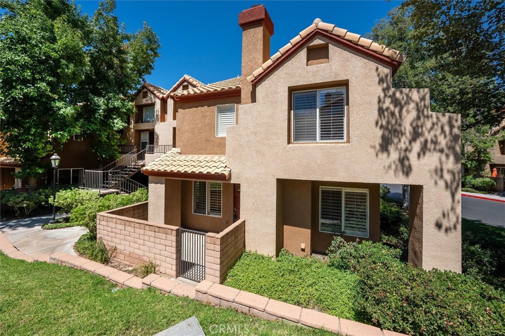 Welcome to this beautifully maintained end-unit townhome in the gated Mountainview Villas community—conveniently located near guest parking and approved for FHA & VA financing! Step through the gated front porch into a warm, inviting living space featuring wood-look tile flooring, added less than six years ago, and recessed LED lighting throughout the main level. The living area is anchored by a beautiful gas fireplace updated with a modern stone facade. The open layout connects the living and dining areas to the kitchen, creating a functional flow for everyday living and entertaining. Custom shutters adorn every window, offering both privacy and timeless style throughout the home. The attached 2-car side-by-side garage offers direct access, and a downstairs half bath features a newer vanity and an oversized storage closet. Upstairs, you'll find dual primary suites, each with its own full bathroom. The larger suite boasts a ceiling fan, walk-in closet, and a bathroom with double sinks and a tub/shower combo. The second suite includes mirrored closet doors, a ceiling fan, and an updated bath with newer vanity and fixtures. Additional highlights include a brand-new AC system installed in 2024 with a transferable 5-year warranty, plus a whole-house fan to help keep things cool in the evenings. Enjoy resort-style amenities with 24-hour security, gated access, a sparkling pool, and spa—all maintained by the HOA. Don't miss this move-in-ready gem in one of the most sought-after communities!