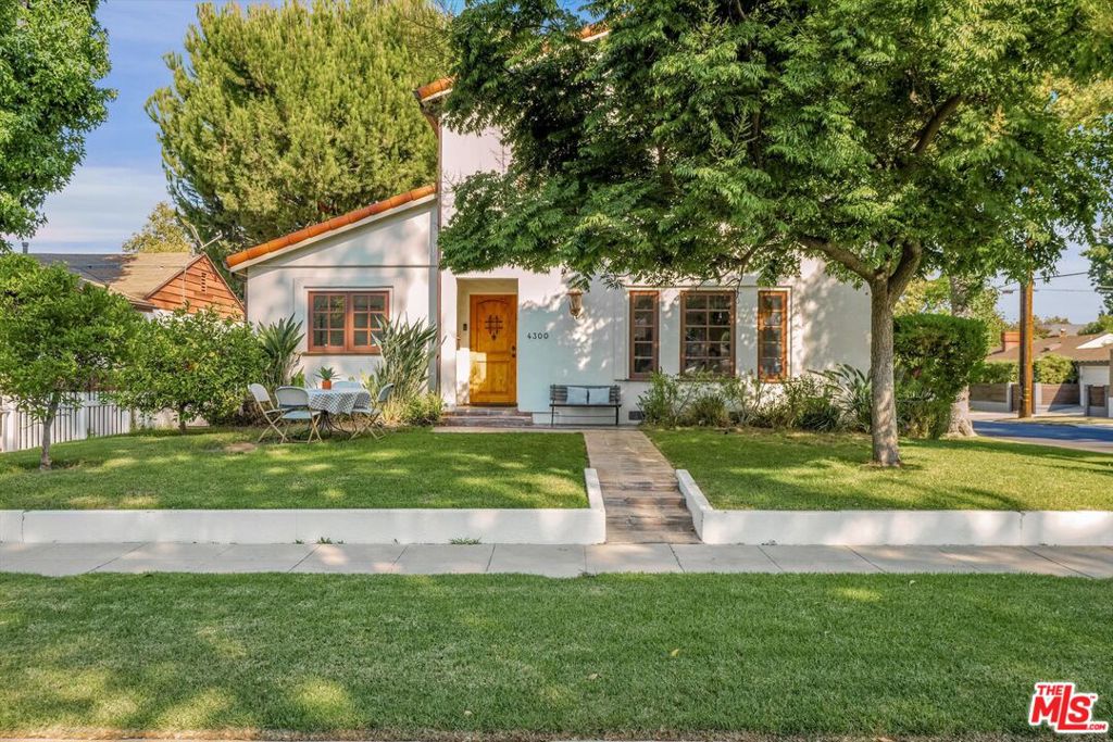 Welcome to Footbridge Square, A Modern Spanish Entertainer's Dream in Prime Studio City. Tucked into the exclusive enclave of Footbridge Square a neighborhood I proudly named - this stunning two-story Spanish revival blends timeless charm with modern upgrades. Sitting gracefully on a coveted corner lot, the home offers five bedrooms, four bathrooms, and a versatile bonus room perfect for a home office, gym, or creative studio. From the curb, the home's arched doorways and romantic facade set the tone for what lies inside. Step through the entry into a cozy formal living room with wood-beamed ceilings and a fireplace, an intimate space that feels both warm and inviting. Beyond, a formal dining room opens to a spacious family room, with French doors that create seamless flow between indoors and out. The chef's kitchen is outfitted with a six-burner Viking range, built-in stainless steel appliances, and a charming breakfast nook. Every detail from hickory hardwood floors to the bespoke under-the-stairs hideaway cupboard adds to the home's unique character. The primary suite is a private sanctuary, complete with a spa-like bath featuring a soaking tub, separate shower, and generous walk-in closet. French doors lead to a serene patio overlooking the lush yard and partial mountain views. A second en-suite bedroom offers added flexibility for family or guests. Outside, the backyard has been transformed into an entertainer's paradise. Multiple sets of French doors open to a covered patio framed by mature olive trees, a fountain, and a hot tubperfect for gatherings both large and small. Additional highlights include a detached two-car garage with extra storage space, proximity to the Carpenter Community Charter School, and walkability to the Studio City Farmers Market and Ventura Boulevard's world-class dining and shops. This home is more than a place to liveit's a modern Spanish retreat designed for both everyday living and unforgettable entertaining. Originally build in 1931, the home went through a total transformation and upgrade in 2007.