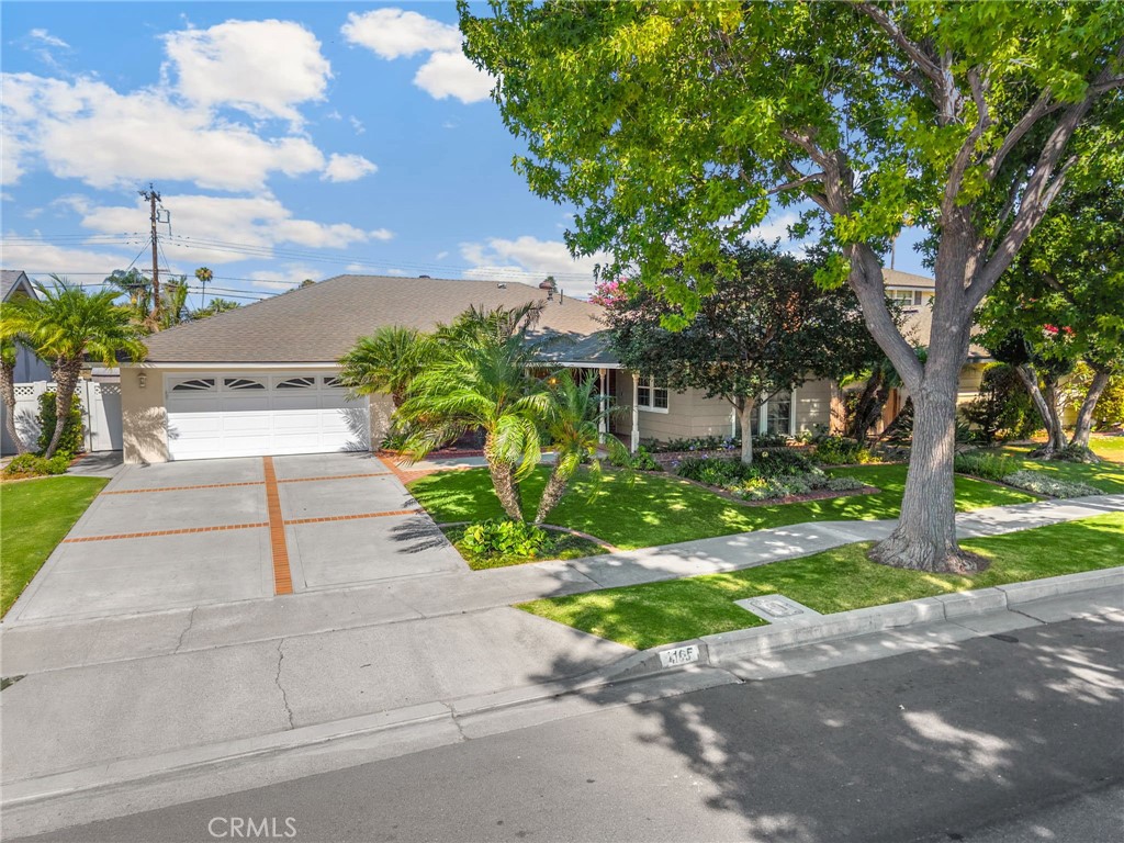 Welcome to this charming single-story residence offering 3 spacious bedrooms, 2 bathrooms, and 1,828 square feet of comfortable living space, all nestled on a generous 7,000 sq ft flat lot. With its inviting curb appeal and an attached two-car garage, this home blends functionality with warmth from the moment you arrive. Step into the welcoming living room, where a large front-facing window fills the space with natural light and frames views of the manicured front yard. Rich wood flooring flows seamlessly through the living areas, complemented by a cozy gas fireplace that anchors the room with a touch of elegance. Just beyond, the dining area sits perfectly between the living room and kitchen, making it ideal for both casual meals and entertaining guests. The kitchen is thoughtfully designed with abundant cabinetry, a charming bay window above the sink, and recessed lighting that brightens every corner. Continue into the family room, where a wide wooden sliding door opens to the backyard, creating a smooth indoor-outdoor connection. Down the hall, you’ll find two comfortable guest bedrooms—one featuring a generous walk-in closet—and a well-appointed guest bathroom with dual sinks, offering convenience and style for family or visitors. The primary suite is a peaceful retreat, boasting ample space, a walk-in closet, and an en-suite bathroom. A window adorned with wood shutters adds a classic touch while allowing for privacy and natural light. The attached garage includes a dedicated laundry area and a versatile storage closet—complete with its own AC vent to keep the space cool and comfortable—making it ideal for a home office, hobby room, or extra storage. Step outside to the backyard oasis, where a large covered patio with two ceiling fans provides a perfect setting for outdoor dining or lounging. A lush grassy area offers room to play or garden, while a tall privacy hedge along the back fence ensures tranquility. Located near award-winning schools, popular restaurants, and abundant shopping options, this home offers not just a place to live—but a lifestyle to love. Don’t miss it!