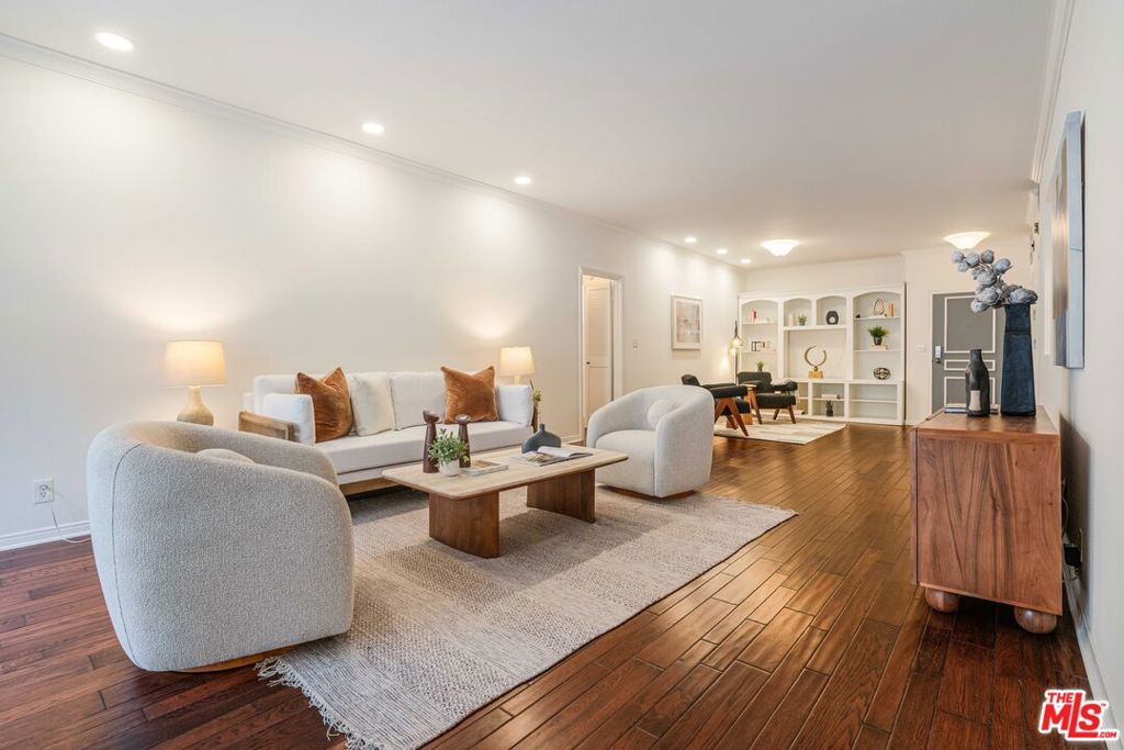 Sophisticated Brentwood Living - a refined urban retreat. Experience the perfect blend of modern sophistication and timeless elegance in this beautifully updated Brentwood condominium, just steps from the vibrant San Vicente Blvd. Situated in a prime location, this residence offers effortless access to Whole Foods, upscale cafes, the Sunday Farmers Market, and acclaimed dining destinations such as A.O.C., Baltaire, Pizzana, and Jon & Vinny's. With seamless connectivity to the 405 and 10 freeways, you're minutes away from Santa Monica, Pacific Palisades, Westwood, UCLA, Bel Air, and Beverly Hills. Designed for both luxury and comfort, this thoughtfully updated home with ample storage has an expansive, light-filled living area, anchored by a charming fireplace that sets the stage for both cozy evenings and elegant entertaining. The open layout extends seamlessly to a private patio, ideal for al fresco dining or tranquil relaxation. The chef's kitchen is a masterpiece of style and functionality, featuring sleek quartz countertops, ample prep space, and brand-new stainless-steel appliances, including a gas range and French door refrigerator. Custom cabinetry with deep drawers ensures effortless organization and abundant storage. For ultimate privacy, the bedrooms are strategically positioned on opposite sides of the home. The primary suite is a serene retreat, offering a spa-inspired ensuite bath with a double-sink vanity, a luxurious soaking tub, and a glass-enclosed shower. A spacious walk-in closets provide exceptional storage. The second bedroom, bathed in natural light, exudes tranquility and is complemented by an updated full bath featuring a chic vanity, glass shower, and stylish flooring. Additional high-end features include a brand-new Samsung washer and dryer, hardwood flooring, and recessed lighting throughout the living and bedroom areas. This exquisite residence embodies the best of Brentwood living - sophisticated, stylish, and effortlessly convenient. A must-see for discerning buyers seeking both luxury and lifestyle!