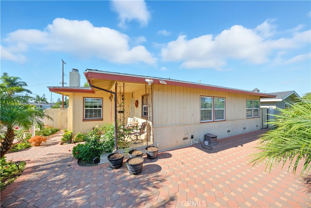 Welcome to 2103 E Nura Place, where thoughtful upgrades, timeless design, and next-level outdoor living come together in one of Anaheim’s most inviting neighborhoods. The property is framed by mature palm trees providing natural privacy and curb appeal. The low-maintenance front yard is both functional and attractive, with an extra-wide driveway offering plenty of parking, including gated RV access for toys, trailers, or future expansion.
Step inside to a spacious living room designed for comfort and style. Featuring high-end tile flooring throughout, a large living space, recessed lighting, and a refined fireplace perfect for cozy nights or entertaining.
The fully remodeled kitchen is a true highlight, boasting brand-new granite countertops, custom cabinetry, top-of-the-line stainless steel appliances, and a newer sliding patio door that floods the room with natural light and opens to the backyard.
This kitchen makes everyday living feel elevated. Off the kitchen is a private indoor laundry room with built-in shelving for added convenience no more trips to the garage or laundromat. Both bathrooms have been tastefully remodeled with clean, modern design and functional layouts. The primary suite features a walk-in shower, perfect for accessibility without sacrificing style.
The bathrooms are spacious with updated fixtures and finishes that feel like a luxury hotel. Now, the backyard is nothing short of incredible. This massive, private outdoor space is thoughtfully designed for entertaining or relaxation. The custom architect-designed patio cover is a one-of-a-kind showpiece, with beautiful craftsmanship and recessed lighting throughout. Whether hosting friends, grilling, or relaxing under the stars, this patio transforms the backyard into an outdoor living room.
Additional features include:
• Gated RV access and parking for multiple vehicles
• Detached garage with serious ADU potential seller has begun architectural plans for a 2-bed, 2-bath unit
Built to last, the home includes major system upgrades,Full copper plumbing, Updated electrical panel, Tankless water heater, 4-ton HVAC system for year-round comfort, 6-year-old roof
Located in a peaceful, established neighborhood and zoned for top-rated schools like Benito Juarez Elementary, South Junior High, and Katella High School, this move-in ready home offers comfort today and room to grow tomorrow.