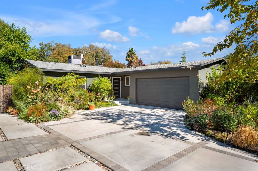 Welcome to this beautifully updated home located south of the boulevard in one of Woodland Hills’ most desirable neighborhoods. The kitchen has been tastefully remodeled with a center island, stainless steel appliances, and opens seamlessly to the dining area and living room—where a cozy fireplace and direct backyard access create an inviting space for relaxing or entertaining. Wood floors flow throughout the home, adding warmth and character. The bedrooms are spacious and full of charm. The primary suite features an en-suite bathroom with stylish modern finishes, while the additional two bedrooms share an updated hall bath. Step outside to an impressive backyard featuring a large covered patio—perfect for outdoor dining and gatherings. The open yard is finished with low-maintenance turf and includes a versatile bonus structure ideal for a home office or studio. Nestled in a mature, picturesque neighborhood, this home is just moments from the award-winning Woodland Hills Elementary School. Enjoy easy access to beaches and Santa Monica via Topanga Canyon, as well as nearby shopping, dining, and entertainment at the Village and along Ventura Boulevard.