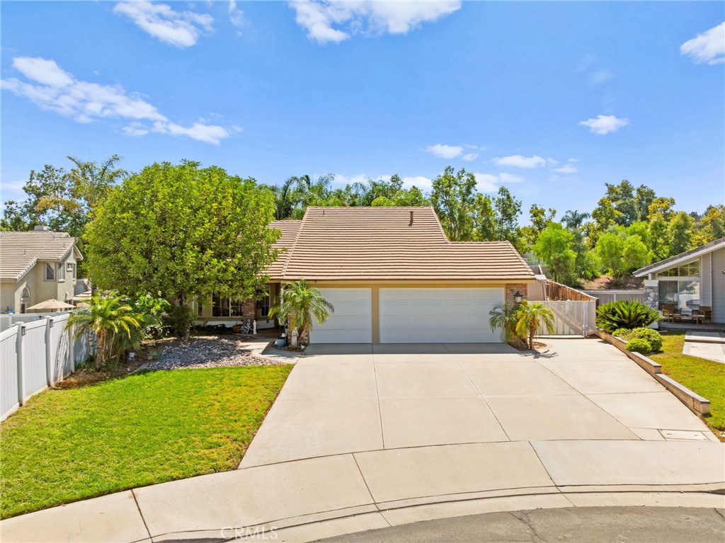 Welcome to this beautifully maintained single-story home in the highly desirable Horsethief Canyon community. Featuring three bedrooms and two bathrooms, this property offers both comfort and functionality in an ideal layout. Step inside to a bright and inviting living room with ample space for entertaining, seamlessly connecting to the open-concept kitchen. The kitchen flows into a separate family room, where large windows provide stunning views of the expansive 10,454 sq. ft. backyard. The bedrooms are thoughtfully situated on the opposite side of the home for added privacy. The spacious primary suite includes a walk-in closet and an ensuite bathroom with dual sinks and a bathtub/shower combo, perfect for unwinding after a long day. This home also features a three-car garage with abundant storage, all set on a quiet cul-de-sac. The oversized lot offers endless possibilities—entertain guests by the outdoor fireplace, relax under the shade of towering palm trees with a hammock, or take advantage of the usable space for an ADU or RV parking. With access to the community amenities, you can enjoy the clubhouse, basketball and tennis courts, a lap pool, gym, sauna, barbecue area, outdoor cooking, picnic spots, and a dog park. Don't forget the low taxes and no Mello Roos! With its rare single-story layout, generous lot size, and sought-after location, this property truly has it all. Don’t miss your chance to call this home yours!