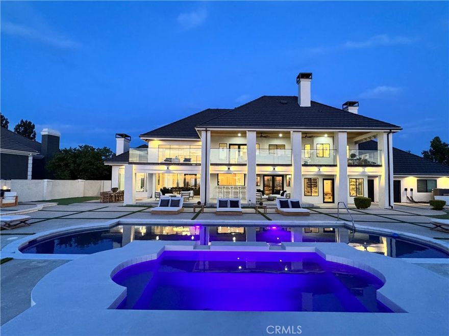Views Views And More Views! Panoramic views surround this professionally remodeled Alessandro Heights custom estate that is being presented for the first time. Over $1.3M in upgrades and organic modern improvements were added to this gorgeous estate situated on this nearly one-acre lot with unobstructed views of downtown Riverside, sparkling city lights, and the majestic peaks of the surrounding mountains. The grand glass pivot door welcomes you into a 20 ft high foyer surrounded by the illuminated stairsteps of the arched wrought iron stairway along with the glowing embers from the linear fireplace affixed in the center of the quartzite natural elements of the wall-to-wall textured stone slabs. Upon entering, your attention is immediately drawn to the floor to ceiling glass wall system that peers out into the resort type atmosphere of the ultimate entertainer’s backyard and the 180-degree views. Dinners accompanied by sunset views will be a daily occurrence. The open design kitchen is wrapped in Honed Marble from Italy, with an 8 ft custom "FlipOut" window for straight through access to the exterior seated bar, along with built-in appliances, wine fridge, and island seating. The family room screams of opulence with the Antolini Textured Quartzite slabs that adorn the fireplace wall as the natural sunlight peers in from the new windows and framed glass French doors. The split-level design includes two main-level bedrooms that share a newly remodeled Jack and Jill bathroom along with another full guest/pool bathroom with direct access to the backyard entertainer’s area. The newly redone mini pebble and glass beads adds an inviting deep blue attraction to the pool and spa and the upgraded LED lights can turn any event into a colorful fiesta. Maybe opt for a game of basketball as you shoot a few hoops instead. At the end of a long day as you walk upstairs to the 2 additional suites, you enter into a massive master bedroom retreat with a glass railing enclosed private balcony engulfed with even more city views. The glow of the fireplace and the sitting tub and walk in shower adorned with Bianco Lasa Polished Marble provides a luxury of nature that faux materials just can’t rival. Prepare for the day ahead in your very own boutique style walk-in-closet before lounging outdoors to catch the cool breeze and evening stars. This stunning turnkey estate features new EVERYTHING, with a rare combination of luxury, modern architecture, unrivaled privacy and seclusion!
