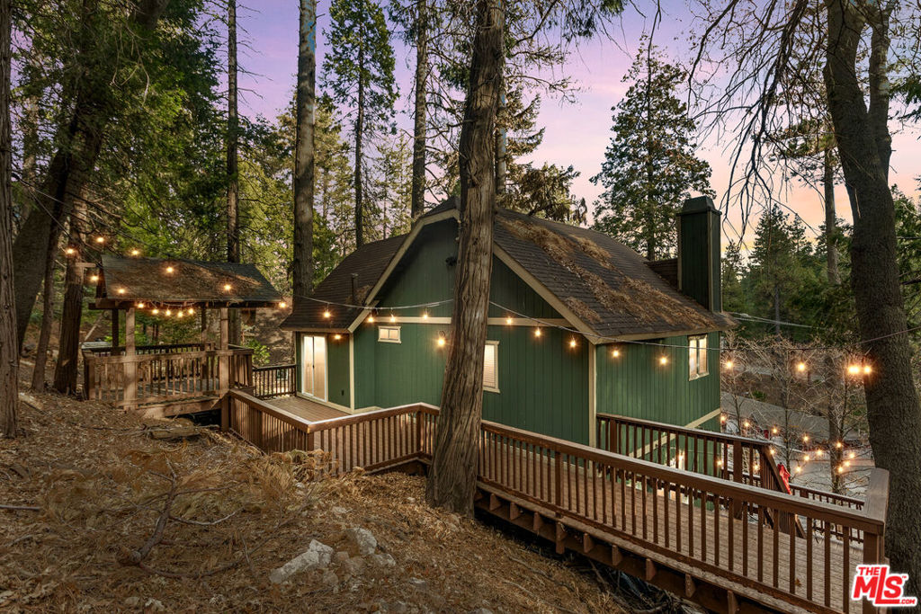 Turnkey Arrowhead Woods Oasis with Full Lake Rights Included! Escape to this sunny mountain retreat in Lake Arrowhead, fully furnished and STR-permitted for instant enjoyment or rental income. Surrounded by towering pines, the updated home offers indoor-outdoor living with low-maintenance Trex wraparound decks perfect for relaxing, entertaining, or stargazing. Enjoy cozy, light-filled interiors with 3 bedrooms, 1.5 baths, a modern kitchen, and a family room that opens to serene outdoor spaces. The primary suite includes a private deck ready for a future hot tub. Everything's ready for you: House comes fully furnished, just bring your clothes or start renting immediately. Includes: Washer / Dryer, NEST smart heat, electric fireplace, newer appliances, house wares, fully furnished bedrooms and bathrooms, kayaks, patio set, BBQ, and expanded winter-ready driveway. This street is snow plowed (higher value) and easy to get in and out. Private lake access and Burnt Mill Beach Club are just steps away, next to Lake Arrowhead Brewing Co. Walk to the Village for dining, music, shopping, and Tesla charging. Minutes from Sky Park and Snow Valley Ski Resort. With lake rights, easy access to Hwy 173/18, and endless outdoor adventure, this is your ideal mountain getaway or income-producing gem.