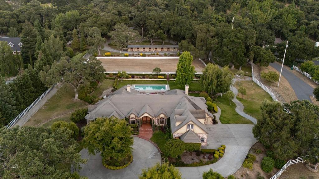 Nestled in the tranquil Sleepy Hollow neighborhood of Carmel Valley, this gated equestrian estate offers spacious luxury living just minutes from The Village's diverse selection of restaurants, shops, and tasting rooms. Featuring three gated entries, this expansive property provides an array of amenities and complete privacy, making it a fully operational and modernized horse property. Highlights include a 5586-square-foot main house, complete with game room, custom chefs kitchen, formal dining, gym, pool and hot tub, guest suite with exterior entrance, radiant heat, dual closets in the primary suite, a three-car garage, and additional bonus storage space. The full-size riding arena, horse walker, three fenced horse pastures, seven separate horse stables, plus tack room, and 3000-square-foot storage and equipment barn offer complete on-site equestrian use. With the beautiful views of the Santa Lucia mountain ranges surrounding, this timeless Carmel Valley estate is ready to welcome home its loving new owners to enjoy for years to come.