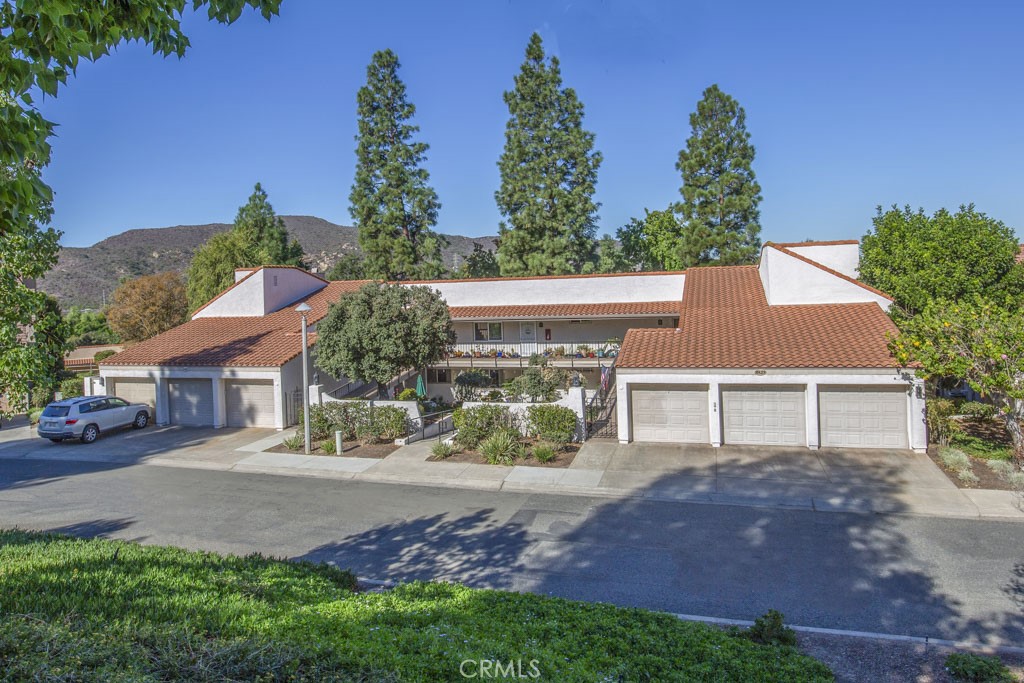 Lovely "LA QUINTA" unique ramp building with no steps to front door. This spacious 2 bedroom, 2 bath unit has newer appliances, full size commercial brand washer/dryer in hallway closet. Unit has a very private outlook from the glass enclosed balcony. Laminate flooring throughout. Although relatively cool unit, there is a heat pump in living and dining room areas, wall unit in master bedroom. This unit's location offers some very nice views of the hillside from the balcony. The detached one-car garage has extra storage. Also included is water, trash, sewer and basic TV cable service through the HOA. Amenities include 27 Hole Championship Golf Course, 2 fully equipped gyms with trainers, over 200 Social Clubs: Bridge, Pickleball, Tennis and much more. Just a short drive to Laguna Beach for dinner, Arts, shopping in their quaint Village. Do not miss this terrific long term rental opportunity in this highly recognized Laguna Woods Village - 55+ Senior Retirement Community.