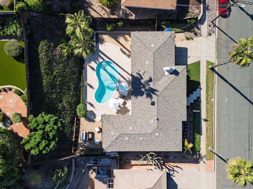 Living the California dream is what this home is all about. This mid-century modern gem is absolutely stunning, set on a palm tree–lined street that perfectly frames endless summer poolside gatherings and the quintessential indoor-outdoor SoCal lifestyle. Step through the front door into a beautifully reimagined interior where modern design meets retro charm. The kitchen was fully gutted and redesigned by a high-end kitchen designer, featuring custom cabinetry, premium surfaces, and top-tier appliances. The flow from the kitchen to the outdoor entertaining area creates the perfect setting for hosting friends and family.  The pool deck was recently resurfaced with natural stone tile, offering a resort-like feel right at home. Major upgrades have already been taken care of for you, including a new roof, energy-efficient dual-pane windows, a relined and descaled sewer line, and a new tankless water heater that provides endless hot water.   With three bedrooms, two bathrooms, 1,716 square feet of living space, and a two-car garage, this home blends timeless style with modern comfort. Its easy indoor-outdoor connection, classic mid-century architecture, and thoughtful upgrades make it a rare find that truly captures the spirit of Southern California living. Located in the heart of La Mesa, it’s the perfect place to relax, entertain, and make lasting memories.