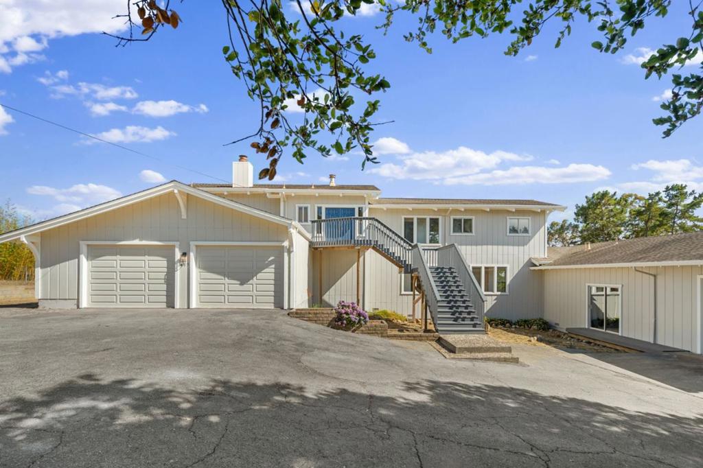 Enjoy the best of coastal living on this peaceful nearly 2.5-acre property, surrounded by rolling hills and natural beauty. Whether you're dreaming of keeping horses, planting a vineyard, or creating a family retreat, this property gives you the space and flexibility to do it. The home features four bedrooms and three-and-a-half bathrooms, with plenty of room to relax and unwind. The primary suite offers amazing views, a large double vanity, and a sunken tub. Step outside onto an updated, spacious deck ideal spots for quiet mornings or hosting friends. There are also two oversized garages with plenty of space for a workshop, storage, or even your RV or boat. There are plans available to build a spacious ADU. While it feels tucked away, the property is just 2 minute drive to Highway 1 and 6 minutes to Manresa State Beach. Easy access to local beaches, shops, and restaurants. This is a rare chance to enjoy privacy and space, while staying connected to everything the coast has to offer.