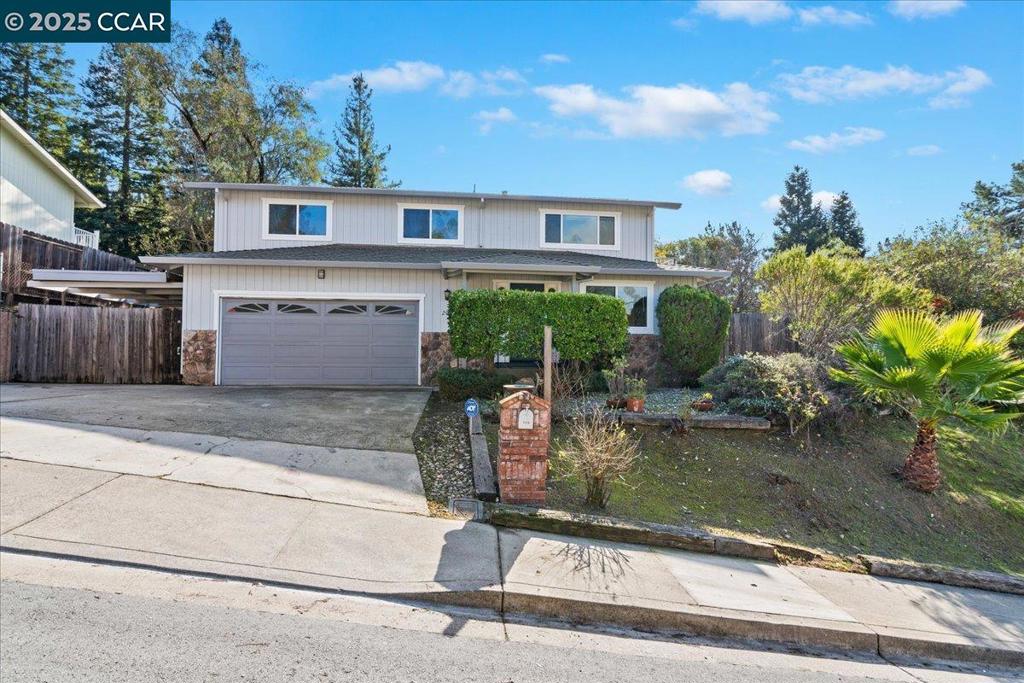 Spacious home on large lot with in-law suite downstairs. Nicley updated kitchen with new stainless steel appliances, skylight, lots of extra cabinet space, breakfast bar and nook. Large back deck, large fenced backyard, side deck, balcony off living room with view of surrounding hills and neighborhood. 3br, 2ba upstairs (including large primary bedroom suite) and 1br, 1ba plus office, kitchenette and den downstairs (large potential in-law suite). Large carport on side of house for potential boat or RV storage. New carpet, flooring and paint. Plenty of off street parking with 2 car garage, side carport and extra wide driveway. Open 1-4pm Sunday 10/19.