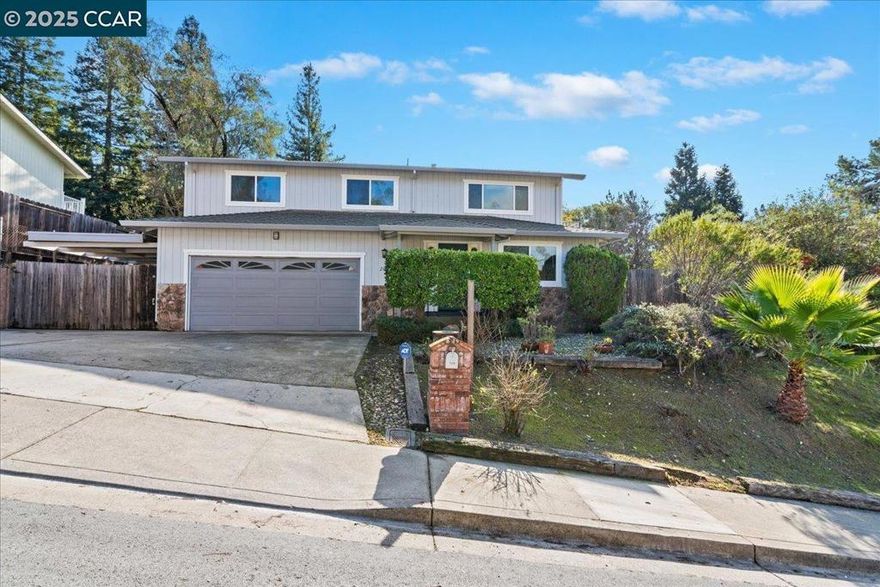 Spacious home on large lot with in-law suite downstairs. Nicley updated kitchen with new stainless steel appliances, skylight, lots of extra cabinet space, breakfast bar and nook. Large back deck, large fenced backyard, side deck, balcony off living room with view of surrounding hills and neighborhood. 3br, 2ba upstairs (including large primary bedroom suite) and 1br, 1ba plus office, kitchenette and den downstairs (large potential in-law suite). Large carport on side of house for potential boat or RV storage. New carpet, flooring and paint. Plenty of off street parking with 2 car garage, side carport and extra wide driveway. Open 1-4pm Sunday 10/19.