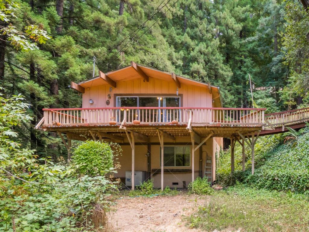 Contractor's Dream at 325 Woodland Dr, Scotts Valley, CA! This 5-bedroom, 2-bath, 2,063 sq ft home sits on a massive 27,312 sq ft lot in a private gated community, offering privacy and exclusivity. Perfectly located just off Hwy 17, it provides easy access to Silicon Valley, blending serene mountain living with proximity to tech hubs. This fixer-upper is a rare chance to transform a spacious home in a prime location into your dream estate or a high-value investment. Dont miss this Scotts Valley gem!