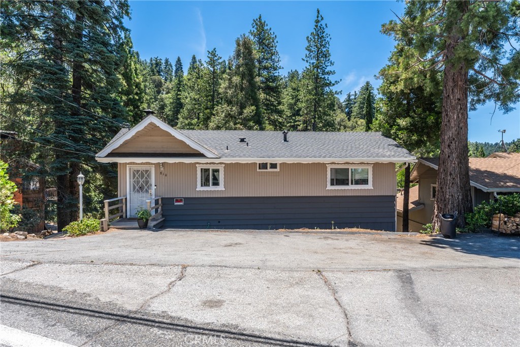 Nestled in the serene and picturesque mountain community of Crestline, this enchanting 4-bedroom, 2-bathroom home offers the perfect blend of comfort, tranquility, and modern convenience. Located just minutes from the pristine Lake Gregory Regional Park which provides beach access, fishing, kayaking, dog park, nature trail etc, and vibrant shopping center, you’ll enjoy the best of both worlds: a peaceful mountain lifestyle with easy access to local amenities. Step inside and be welcomed by a warm and inviting living room featuring a traditional brick fireplace, ideal for cozy evenings during chilly winter nights. The central heating ensures year-round comfort, while the spacious layout allows for relaxed living and easy entertaining. From the living room, large glass pane door leads to a private deck, providing stunning views of the surrounding forest of towering pine trees—perfect for outdoor gatherings or simply unwinding in the fresh mountain air. The lower level boasts a generously sized bedroom, which also opens onto a second deck. Wake up to the morning sun filtering through the trees and enjoy a peaceful moment in the heart of nature. This home offers an incredible opportunity for anyone seeking a mountain escape that doesn't sacrifice convenience. County snowplowing service during winter months for easy access to your driveway provides easy maintenance. Furnace with 8 year warranty and double pane windows provide peace do mind during the cold winter months. Whether you’re looking for a year-round residence or a weekend retreat, this property is a must-see. Don’t miss out on the chance to make this peaceful haven yours!