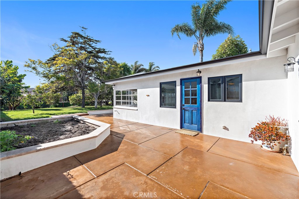 Welcome to this unique opportunity, nestled on a spacious lot just a short stroll from T-Street Beach, this single story home welcomes you with an airy open-concept layout that invites an abundance of natural light with a large private yard engulfed with mature trees and landscape. A blend of modern design and rustic charm creates a warm and inviting atmosphere throughout. Inside, you'll find wide-plank luxury vinyl flooring, vaulted beamed ceilings, wood-cased windows, oversized barn doors, and an open concept sunroom that leads to the outdoor living areas, patio and yard. The kitchen is equipped with custom cabinetry, a large single-basin sink, high-end LG stainless steel appliances, and a peninsula with seating. The primary bedroom and bathroom offer a luxurious retreat with a quartz-topped dual vanity, a generously sized wood-framed mirror, a stylish frameless walk-in shower with patterned tile, and ample linen storage. Outside, the property features a spacious lawn for entertaining, relaxing, sunbathing or just to stroll around, a concrete patio with a built-in planters, and multiple areas for activities. Walk-through you secret bookshelf door onto the attached two-car garage with ample storage cabinets, a convenient laundry area, and updated plumbing and electrical systems throughout. This is your opportunity to walk to the beach, and explore what San Clemente has to offer. Conveniently located to Shops, Dinning, and Stores and easy for commuting.