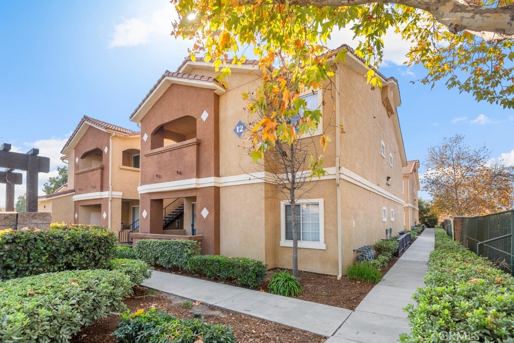 Nestled in the exclusive gated community of Madison Park Villas, this move-in-ready second-floor condo offers comfort, style, and convenience. Featuring 1 bedroom, 1 bathroom, and a brand new HVAC and water heater, this home is ideal for easy living. Inside, you'll be welcomed by beautiful laminate wood flooring throughout, a cozy living room with a fireplace, and a sliding glass door that opens to the balcony, offering peek-a-boo mountain views. The well-equipped kitchen boasts: A breakfast nook and dining area, modern appliances, including a microwave, stove, and dishwasher, plenty of cabinet space, and a nearby laundry room for added convenience. Adjacent to the dining area, you’ll find a versatile bonus room that can be used as pantry storage or an extra closet. The primary bedroom includes a walk-in closet and a ceiling fan for optimal comfort. Additionally, the unit comes with a covered carport parking space and an open car space. Madison Park Villas offers resort style amenities, including: A swimming pool and spa, clubhouse, and gym/exercise room. Conveniently located near shopping centers and major freeways, this condo is a perfect blend of tranquility and accessibility.