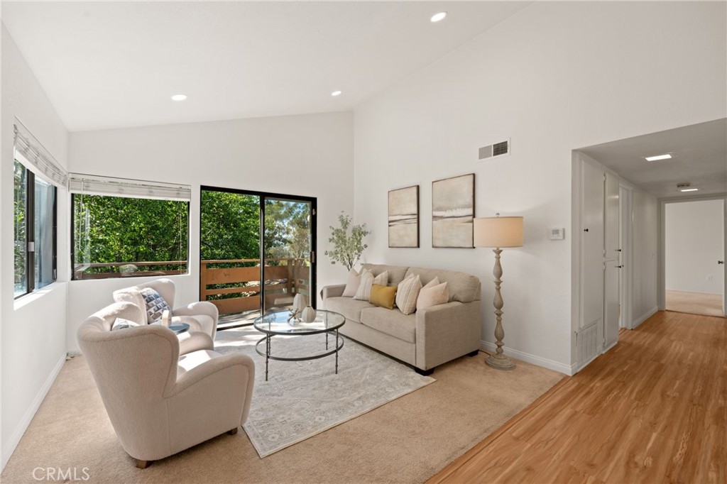 Welcome to this beautifully renovated 2-bedroom, 2-bathroom end unit in the highly sought-after gated Diamond Bar Tennis Club. Perched atop a hill with 24-hour security, this second-floor unit offers serene views of lush greenery and mature trees. Inside, enjoy soaring cathedral ceilings, abundant natural light, and a spacious layout. The primary suite features a walk-in closet, and recent upgrades include fresh interior paint, newly painted kitchen cabinets, marble countertops, updated vanities, recessed lighting, and modern fixtures. The HVAC system is less than five years old, and two assigned carport spaces are included. The HOA covers water, trash, exterior insurance, and provides access to resort-style amenities including pools, spa, tennis courts, clubhouse, and beautifully landscaped grounds. Located minutes from Diamond Bar Golf Course, shopping, dining, and with quick access to the 57 and 60 freeways, this is a rare opportunity to own one of the best-value homes in Diamond Bar.