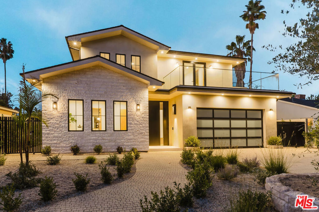 Introducing a new built architectural masterpiece that epitomizes modern elegance and luxurious design. Encompassing approximately 4,000 square feet of exquisite finishes, the main residence offers five spacious bedrooms and four and a half baths, a detached 1BR / 1BTH ADU, and several outdoor spaces. The heart of the home is an open living space, featuring a gourmet kitchen and an airy breakfast nook. The living area flows seamlessly outdoors to a private oasis, complete with a pool and spa, a chic BBQ area, and a heated covered patio, perfect for entertaining. Upstairs you'll find a stunning primary suite, with a dazzling bath and a walk in closet, additional three bedrooms and two baths, and two large balconies. The ADU provides additional flexible space for guests, yoga studio, or an office, for a trendy and sophisticated lifestyle. This home embodies contemporary opulence in the heart of Valley Village, crafted for those who appreciate style, luxury and functionality.