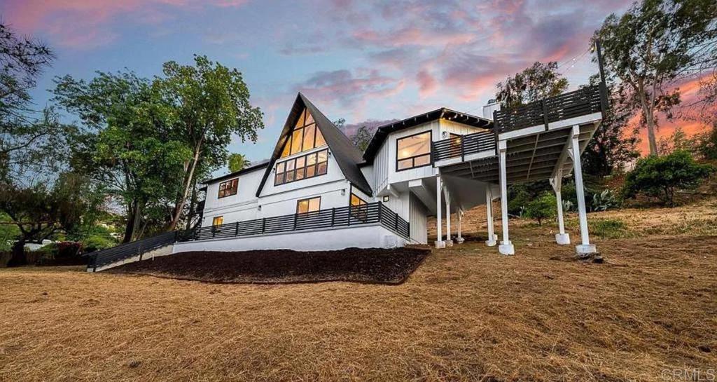 Welcome to 868 Washington Heights Rd — a one-of-a-kind A-frame-inspired retreat on a private 0.5-acre lot, boasting jaw-dropping mountain and sunset views. This fully remodeled 4-bedroom, 3-bathroom masterpiece blends striking design with top-tier functionality and modern luxury. Inside, White Oak luxury vinyl plank flooring runs throughout an airy open-concept layout. The dramatic circular-ceiling lounge with exposed beams sets the tone for the home’s bold style. The designer kitchen features quartz countertops, high-end stainless steel appliances, a pot filler, exposed wood beam ceiling, and a built-in pantry for optimal storage. An upstairs loft offers flexibility as a 5th bedroom or bonus space, while a dedicated office showcases stunning A-frame views. All bathrooms are finished in Portola’s signature “Dune Shack” limewash, and the spa-like primary suite impresses with floor-to-ceiling porcelain tile, a large walk-in closet, and a luxurious layout. Upgrades include a new HVAC system with all-new ducting and vents, a new water heater, LED lighting throughout, and an oversized, finished 2-car garage with epoxy floors — lift-ready and perfect for car lovers or workshop enthusiasts. Step outside to enjoy a rebuilt view deck with firepit, turf-inlaid driveway, and professionally designed landscaping — perfect for entertaining or unwinding in complete privacy. Bonus: Seller is open to offering a credit toward a 2-1 interest rate buydown — ask how this can dramatically lower your monthly payments in the first two years. Style, substance, and serious incentives — this home has it all.