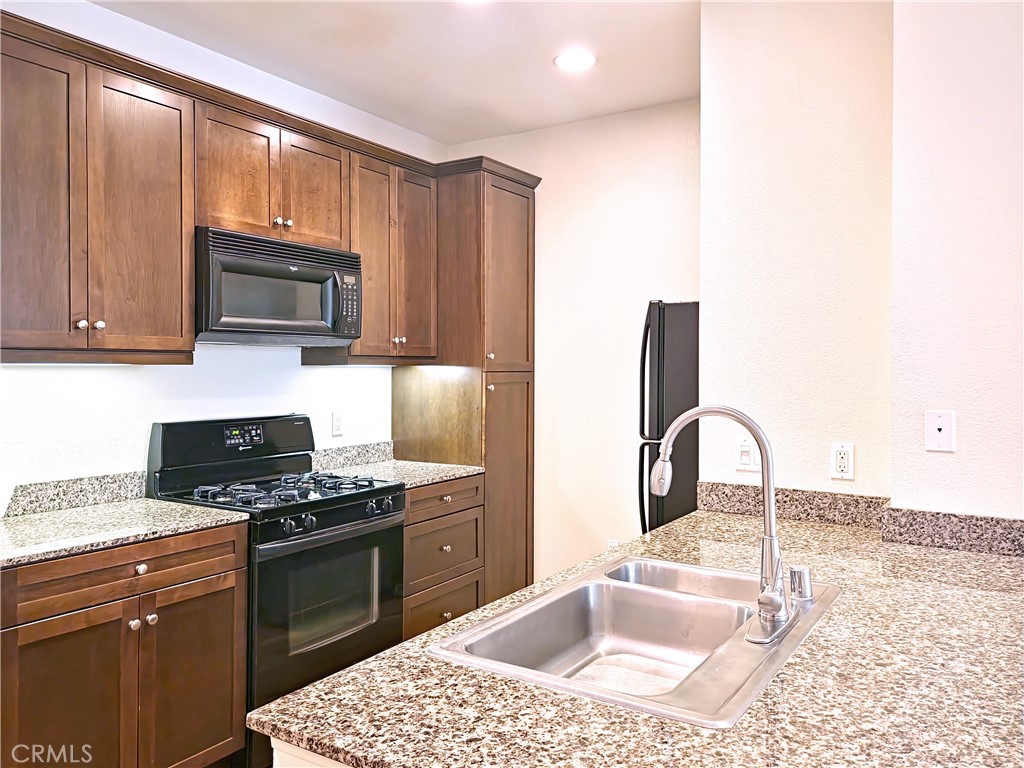 Private and peaceful, this beautifully updated third-floor condo overlooks the quiet inner courtyard at Avenue One, offering a serene and tranquil setting. The spacious 1-bedroom, 1-bath home features approximately 734 square feet, an assigned parking space in the secured parking structure, granite countertops, sleek European-style cabinetry, all black Whirlpool appliances, a high/low double-basin stainless steel sink, and energy-efficient dual-pane windows that create a comfortable, retreat-like atmosphere. Enjoy resort-style amenities including a sparkling pool and spa, fitness center, indoor basketball court, business center, conference room, putting green, clubhouse, media lounge, billiards, BBQ area, and tot lot — all ideally located near the San Joaquin Nature Preserve, shopping, dining, and major freeways.