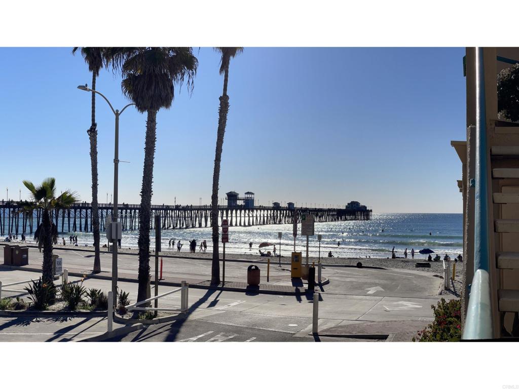Picture perfect first floor residence in San Miguel III - Ideal open concept floorplan with private balcony boasting direct beach and pier views. Interior has been recently refreshed with numerous improvements. Kitchen area opens to family room w/ glass fireplace and drinks counter. Spacious primary suite with walk-in shower & vanity. Large secondary bedroom w/ bath. Rare: Air Conditioning added and new water heater. Elevator access from secured parking (2 Deeded Spaces) with ample guest parking. San Miguel resident amenities includes turf areas, spa(s) and gated access to North Pier Beaches. Walk outside to famed Oceanside Pier, marina and Michelin star rated restaurants.