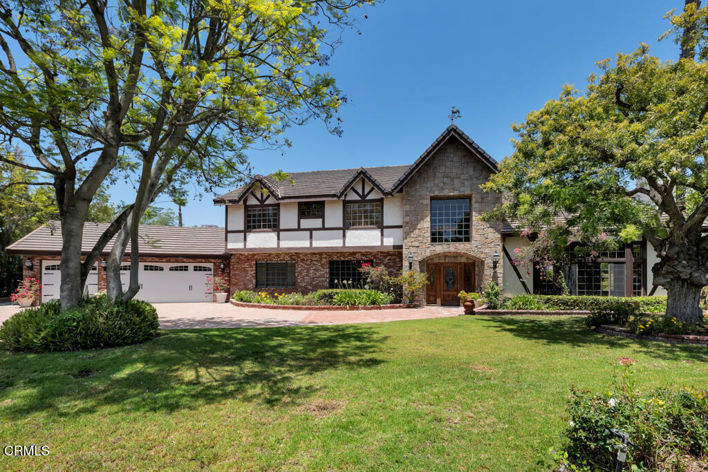 Perched above the valley behind private gates on just over an acre, this custom Tudor-inspired estate blends rich timeless architecture, storybook charm and old-world elegance offering sweeping panoramic valley and mountain views. The grounds are rich with mature fruit trees, lush gardens, pool, spa, sport court and room to roam. Truly a special property in a coveted hillside neighborhood rich with character.