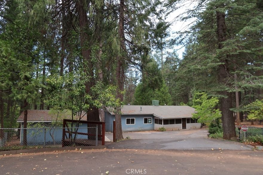 This HUD-owned property offers 2 bedrooms, 2 bathrooms, and approximately 1,440 sq. ft. of living space on a .35-acre lot at the end of a quiet cul-de-sac in Magalia’s Paradise Pines community. The home appears clean and presents a real opportunity for buyers to update and make it their own.



The property includes a detached garage with additional parking, a fully fenced yard, and a covered front porch. Exterior features include a composition roof and aluminum siding, which adds durability and is fire-resistant—a practical benefit in this area. Inside, vaulted ceilings, a fireplace, and dual-pane windows provide functional living space. The primary suite has an attached bathroom with a Roman tub, while the covered and carpeted sunroom porch and large back deck offer extra space for living or outdoor enjoyment.



Paradise Pines residents have access to community amenities including a clubhouse, pool, spa, tennis courts, and more.



This is a HUD home being sold as-is, offering solid square footage, functional features, and a quiet cul-de-sac location—a practical option for anyone looking for space, privacy, and potential in a mountain community.