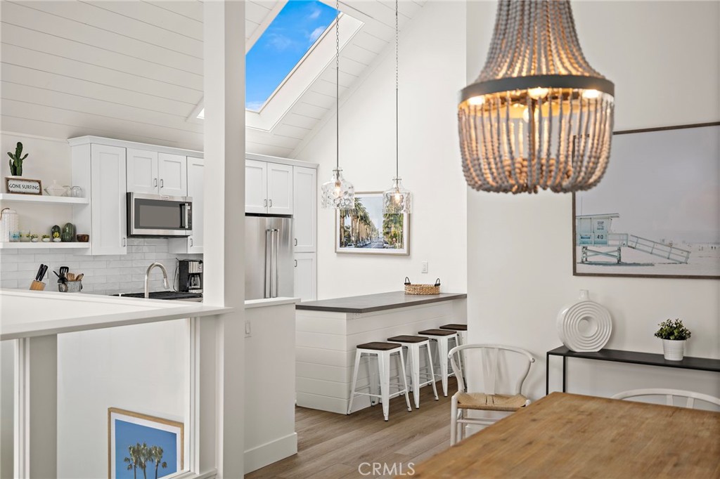 Soaring ceilings, light, bright, and open 207 40th Street, Unit B upstairs! A rare blend of quality, value and space. One of two available units, sold separately or together, each with a coveted active short-term lodging permit fully transferable to the new owner. The 3-bedroom, 2-bath layout is designed for the beach lifestyle, with dramatic vaulted ceilings throughout, including a spacious primary suite with private patio. Totally remodeled and professionally furnished, this property is ready to enjoy from day one—whether as a getaway, family beach pad, or high income-generating rental. The interior is styled in a coastal urban-chic aesthetic with light wood accents and beach-inspired tones and air conditioning. Everything you need is already here from the furnishings to the beach gear making this an easy, turn-key operation. Located just 11 houses from the sand and 4 houses from the bay in one of Newport Beach’s most consistently desirable zones of the Newport Peninsula. (see the upstairs unit also for sale @ 207 40th St)