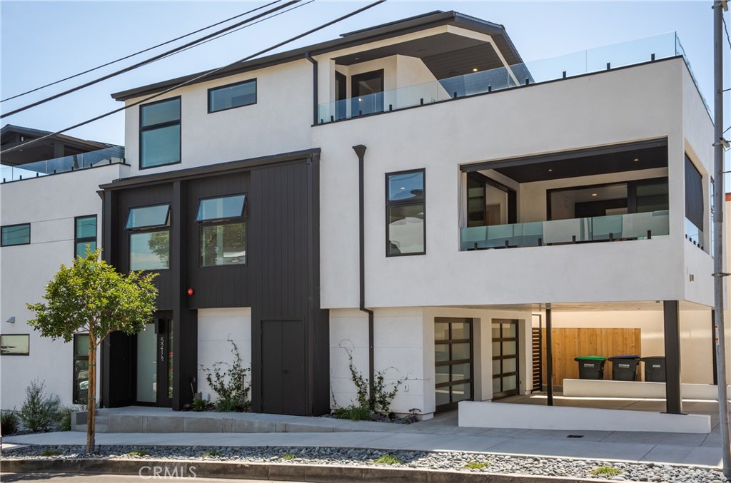 The Flower Streets, Tucked into the heart of Corona del Mar’s Village, 521 ½ Iris Avenue blends modern design with the relaxed charm of coastal living. This brand-new back unit built in 2024 is more than a home—it’s a lifestyle. Wake up and stroll to local cafés, spend afternoons at world-class beaches just blocks away, and enjoy evenings on your rooftop patio with panoramic city-light views. The residence offers approximately 1,100 square feet across three levels, with two bedrooms and two-and-a-half baths. An open-concept main level flows seamlessly from the living and dining areas into the kitchen and out to a covered deck, creating an effortless indoor/outdoor vibe. Thoughtfully designed with details like wide-plank white oak flooring, vaulted ceilings, custom tilework, accent walls, and indoor/outdoor audio, the home combines comfort with sophistication. The one-car garage features epoxy flooring and a modern glass roll-up door, complemented by an additional covered parking space. The chef-inspired kitchen showcases quartz countertops, white oak cabinetry, Thermador appliances—including a built-in refrigerator—open shelving, and a pot filler. Upstairs, the primary suite offers a private balcony, a walk-in closet, dual sinks, and a floating vanity. Clean, contemporary architecture enhances the exterior, while the unbeatable location puts you close to Fashion Island, Laguna Beach, boutique shops, top-rated schools, and the vibrant everyday energy of the Village.