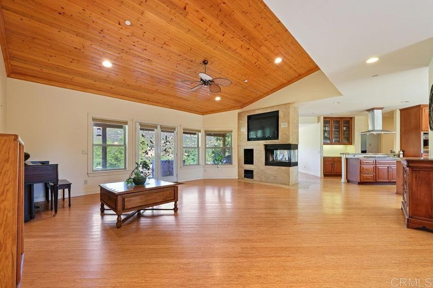 Escape the city and settle into your own private retreat in Jamul’s beautiful Deerhorn Valley, where wide-open skies, mountain views, and peaceful living define every day. This custom home, built in 2010, combines modern comfort with natural surroundings, offering an open floor plan, soaring wood ceilings, and walls of windows that bring the outdoors in. The main residence features a large open kitchen with granite counters, stainless steel appliances, and a large island designed for entertaining. In addition to the other two bedrooms, the primary suite features a gas fireplace and opens to high vaulted ceilings. The spa-style bathroom is equipped with dual sinks, a private sauna, oversized soaking tub, and a walk-in shower. Step outside and you’ll find an entertainer’s dream. Expansive patio space with pizza oven, endless-swim spa, and fireplace. A separate casita studio with its own access and parking is ideal for guests, extended family, or rental income. With a horse corral already in place, flat usable land, and a fully owned solar system for true energy independence, this property is ready for both comfort and creativity. The landscaping is a blank canvas, giving you the freedom to design your dream setting—whether that’s lush gardens, a private vineyard, expansive outdoor living spaces, or a resort-style backyard built for entertaining. This is more than a home, it’s a lifestyle in one of East County’s most desirable neighborhoods.