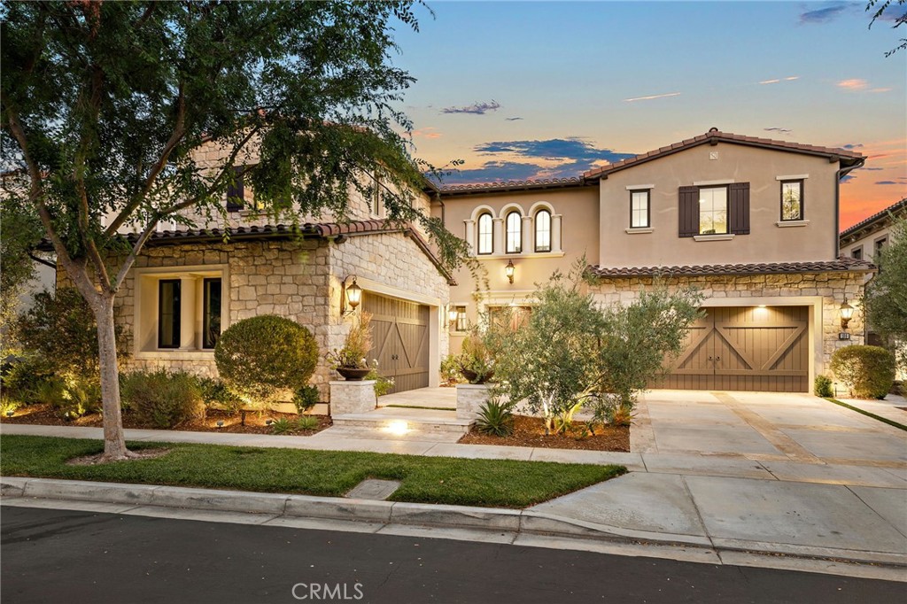Welcome to the prestigious "Santa Monica" residence from the exclusive Marbella Collection by Toll Brothers, ideally situated on a premium cul-de-sac lot in Hidden Canyon—one of Southern California’s most coveted gated communities. This stunning Tuscan-inspired estate offers 5,923 square feet of luxurious living space on an 8,520 square foot lot, showcasing the largest floor plan available in the collection. Designed to impress, the home features a grand double-height foyer with a sweeping curved staircase, a custom conservatory/den with ornate iron doors, and a spacious 4-car garage. Dramatic 90-degree sliding pocket doors seamlessly blend indoor and outdoor living. With 5 bedrooms, 5.5 bathrooms, and a generous upstairs bonus room, there’s ample space for both elegant entertaining and comfortable everyday living. The open-concept layout flows effortlessly into a resort-style backyard, complete with a custom pool and water features, spa, built-in BBQ, fire pit, and multiple covered outdoor seating areas. The chef’s kitchen is a true showpiece—featuring dual islands, granite countertops, extended floor-to-ceiling cabinetry, top-of-the-line stainless steel appliances, and double SUB-ZERO refrigerators and freezers. Residents of Hidden Canyon enjoy world-class amenities including a 24-hour staffed gated entrance, junior Olympic pool, clubhouse, cabanas, and scenic hiking/biking trails. Located within the award-winning Irvine Unified School District and just minutes from the Irvine Spectrum Center, Quail Hill Shopping Center, and Laguna Beach, this is Southern California luxury living at its finest.