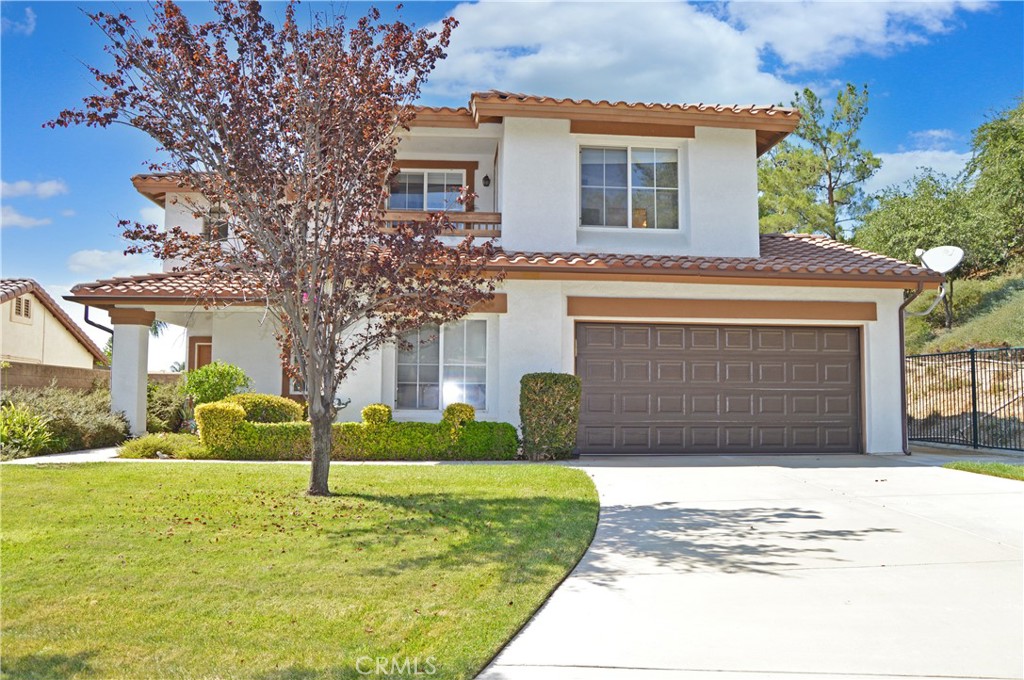 Welcome Home to 11718 Pactfield Place in Yucaipa's Desirable Chapman Heights Community at the End of a Cul-de-Sac! Enjoy gatherings with loved ones in this light, bright, spacious home with so much flexibility due to separate, but open living areas you're sure to love. Pass by the cottage-garden-style flower beds with butterflies flitting about to the covered front porch, then step into the tiled entry which opens to the expansive, open-style living space. The living room boasts double-height ceilings and flows into a second space which can be used as an extension of the living room, a family room, or a formal dining room with a niche open to another room which offers a cozy fireplace, raised hearth and wood-look tile flooring adjacent to the kitchen - perfect for a family room, breakfast nook, or even an artist’s studio. The kitchen offers a tiled breakfast bar with inset granite for dough-making or other food prep needs, a pantry, ample counter & cabinet space, tile flooring, & lots of natural light. A sliding door leads to the backyard with a large patio and lush, green lawn surrounded by vinyl fencing on two sides & wrought iron fencing open to views of the green space to the north. Yes, the main floor offers the convenience of a good-sized guest bedroom, a bathroom with a walk-in shower & a laundry alcove with a window to the front yard. Upstairs, the very spacious main bedroom suite is separated from the other bedrooms for added privacy and includes a retreat (perfect for a sitting area, nursery, or home office), a balcony with sweeping views to enjoy while sipping your morning coffee, an en suite bath with separate soaking tub & shower, dual sinks, & a walk-in closet. Down the hall, you’ll find a full bath & two more bedrooms with views of the distant foothills & city lights. Throughout this home, you’ll enjoy an abundance of natural light complemented by neutral tile & carpet, & white paint - a perfect backdrop for your personal color palette. The 6,956 sq ft cul-de-sac lot boasts no neighbors to the north & an oversized driveway leading to the 2-car garage. Chapman Heights HOA offers low dues in exchange for an attractive, well-maintained community close to shopping, dining, schools, and more. What are you waiting for? Take a tour, then make this amazing house your next HOME!