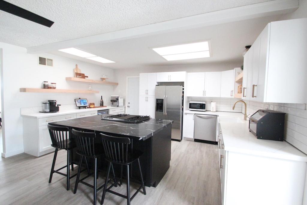 Welcome to this beautifully updated ranch-style home with ADU, offering 1,883 sq. ft. of versatile living space. Inside, you'll find a newly remodeled kitchen (2025) with quartz countertops, stylish finishes, and a custom coffee bar with beverage fridge. The bathrooms have been updated, the home features fresh paint throughout, and the living room with fireplace creates a warm, inviting atmosphere. A separate family room adds flexible space for entertaining, work, or play.Practical upgrades include a new exterior AC unit (2022) and solar panels providing 129% energy offset, keeping utility costs low. Outdoors, enjoy a large, fully fenced property with two gated driveways, a pedestrian gate, and a spacious backyard featuring a lemon tree, tangerine tree, and storage shed.The property also includes a private-entry ADU, fully equipped with its own kitchen, bathroom, walk-in closet, and fireplace, ideal for multi-generational living or guests.This home offers the perfect blend of comfort, efficiency, and flexibility. Ready for you to move in and enjoy.