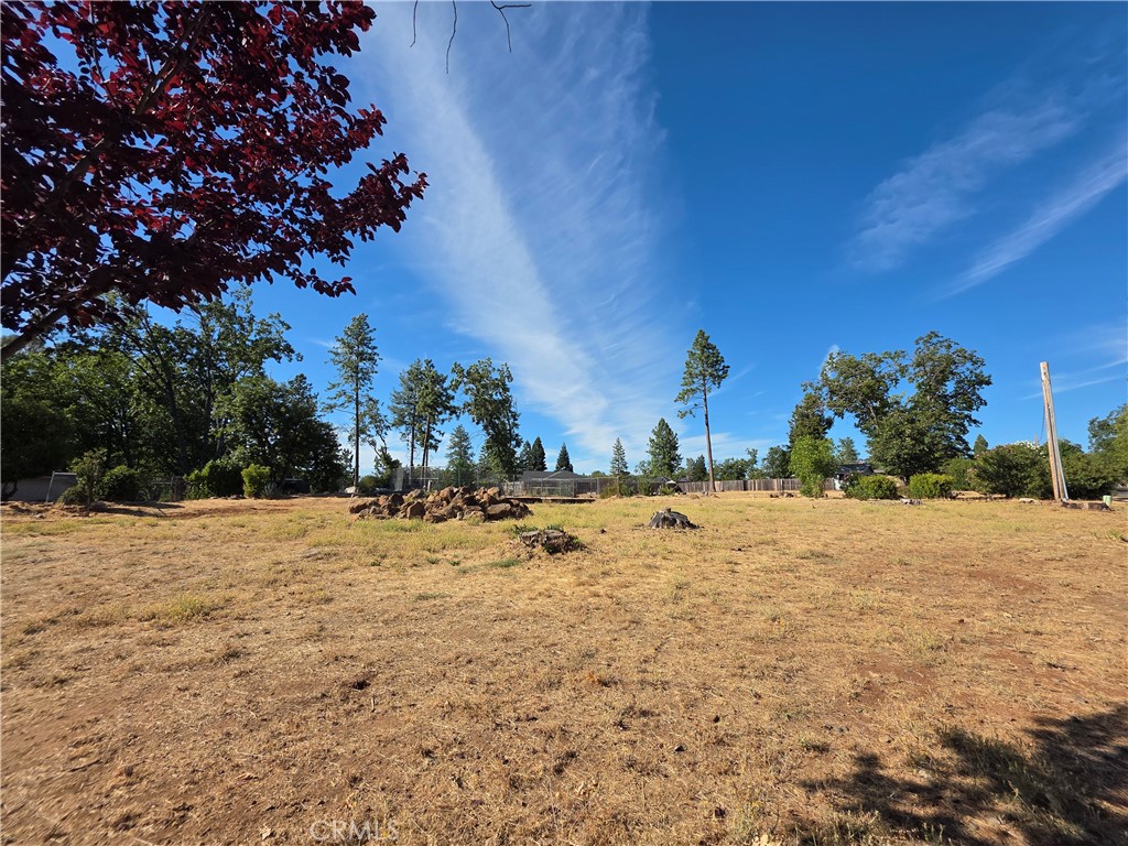 Situated in one of the most scenic and desirable neighborhoods in Paradise, off Valley View Drive, this half-acre lot at 219 Redbud Drive features a large swimming pool that could be refurbished to restore it to its original splendor, where it once accompanied a fantastic 2,500-square-foot home. This spacious lot is surrounded by newer luxury homes, attracting potential buyers who are eager to build their dream home in this developing area, all while enjoying breathtaking sunsets every night. Utilities are readily available just off the street; however, the condition of the septic system is unknown. Buyers are encouraged to investigate all aspects of this promising property.