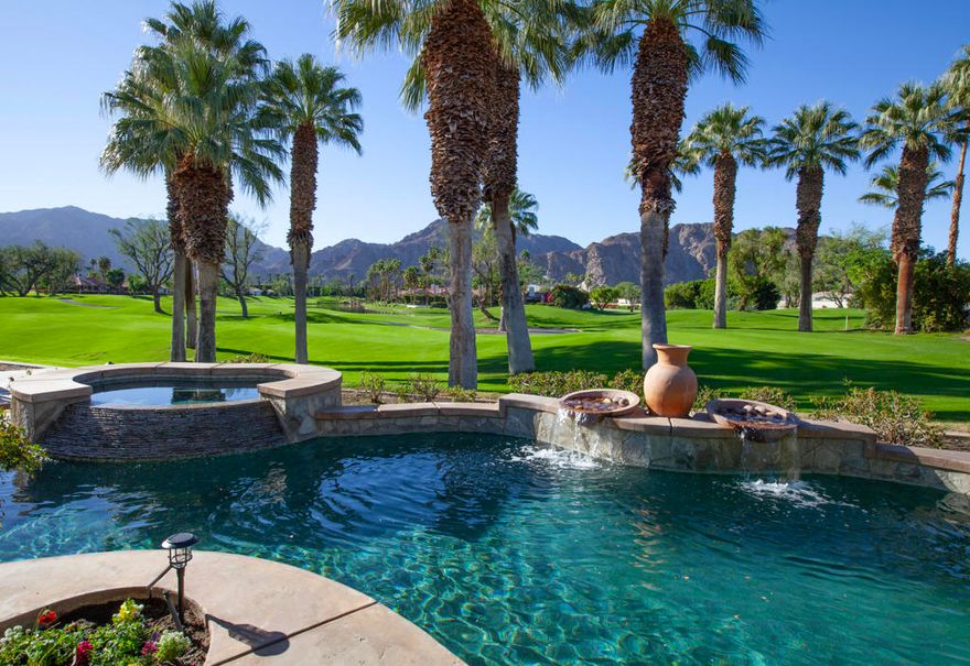 Experience elevated desert living in this beautifully appointed residence, perfectly positioned on a quiet cul-de-sac within the sought-after Rancho La Quinta C.C community. From its captivating Santa Rosa Mountain foothill views to the sweeping multiple fairway and lake vistas, this home offers an idyllic blend of comfort, elegance, and breathtaking scenery. A generous multi-car driveway and desirable two-car plus golf cart garage set the tone for convenience and curb appeal. Step through the private entry courtyard, where a sense of tranquility welcomes you inside. The dramatic foyer with soaring high ceilings introduces an interior filled with warmth, natural light, and timeless style. The main living area features a romantic fireplace with tile and stone accents, paired with a custom built-in entertainment unit--the perfect setting for both quiet evenings and social gatherings. Neutral ceramic tile flooring in common areas balances beautifully with the carpeting in the living room and bedrooms, creating a cohesive and inviting feel throughout the home. Entertaining is effortless with the wet bar boasting granite counters, ideal for hosting friends and family. The dining room enjoys a private view, making every meal a memorable experience. The primary bedroom suite is a peaceful sanctuary with inspiring mountain and golf course views to greet you each morning. All bedrooms are ensuite, offering privacy and comfort for guests. Custom window coverings, including blinds, provide control over natural light while enhancing the home's refined appeal.Outdoor living is as impressive as the interior. Multiple seating and lounging areas invite you to relax while taking in the beauty that surrounds you--majestic mountains, rolling fairways, and a serene lake that reflects the colors of the desert sky. It is a setting designed for morning coffee, sunset cocktails, or evenings under the stars.Important upgrades add value and peace of mind, including replaced air conditioning systems and a newer hot water heater, ensuring comfort and efficiency. Please see Amenities List. This home embodies the essence of desert resort living--ideal as a full-time residence, seasonal getaway, or investment opportunity in one of La Quinta's most desirable communities. With exceptional views, thoughtful design, and an unbeatable setting, this is a retreat you will enjoy for years to come.