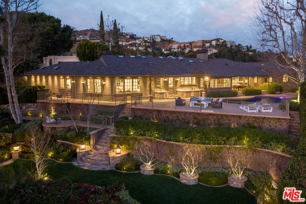 EightyEight SixtySix is a consummate corner lot etched above the Sunset Strip. Perched on the seminal Bird Streets is your single-story contemporary nest emanating endless outdoor living & 270 of heart-stopping Southern California views. Minutes from the 90210, bask in Hollywood legacy overlooking the city from nearly every room. Through a herringbone hardwood floored formal living showcasing a marble fireplace & coffered ceiling is your secluded retreat. Viking appliances, U-Line wine fridges & a walk-in pantry comprise your center island chefs kitchen with custom tile backsplash. Your primary view-suite is accentuated by a marble fireplace, walk-in closets & the highest-quality detailing between the dual vanities & glass shower. Expansive outdoor grounds offer a large pool, patio, BBQ, a perfectly manicured grass backyard w/charming gazebo & views.