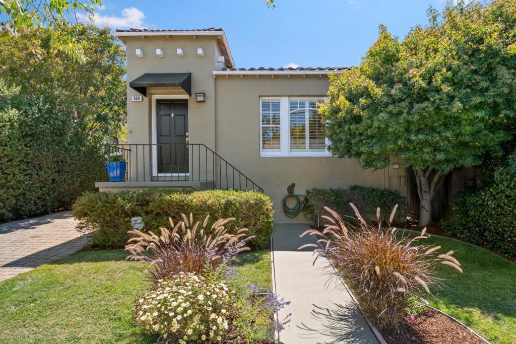 This beautifully maintained Mediterranean-style split-level home blends original architectural details with contemporary upgrades. The lower level features a spacious family room with recessed lighting, and bright accent windows, complemented by a second full bathroom. French doors open to a large, tiled courtyard ideal for outdoor entertaining. The private, lushly landscaped garden and yard offers a serene retreat. Inside, the elegant open-concept living, dining, and kitchen areas showcase a coved ceiling and a striking granite-faced fireplace. The updated kitchen includes granite countertops, stainless steel appliances, skylight, birch cabinetry, and a welcoming breakfast bar. Upstairs, two full bedrooms feature custom plantation shutters, gleaming hardwood floors, and double-pane windows. The remodeled designer bathroom boasts marble and tile accents, a relaxing soaking tub, and a separate stall shower. The larger bedroom offers French doors opening to a period-inspired tiled balcony with wrought iron railing. Additional highlights include a full basement with laundry area, abundant storage, and potential for a wine cellar or home gym. This unique and versatile home is a true gem that combines sophistication, comfort, and classic Mediterranean appeal.